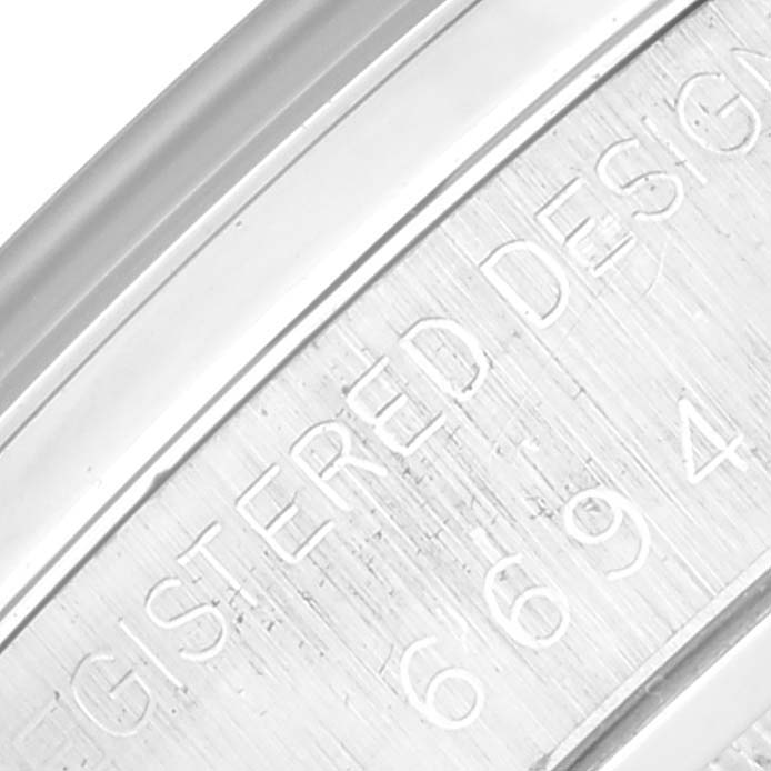 This image shows a close-up of the engraved side of the case back of a Rolex Vintage Collection 6694 Men
s Stainless Steel Grey Dial 6694 Men
s Stainless Steel Grey Dial watch.