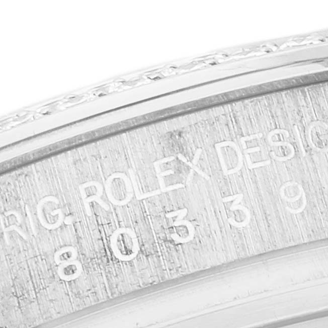 The image shows a close-up of the engraved bezel and case of a Rolex Pearlmaster 80339 Women's White Gold Mother of Pearl Dial 80339 Women's White Gold Mother of Pearl Dial watch.
