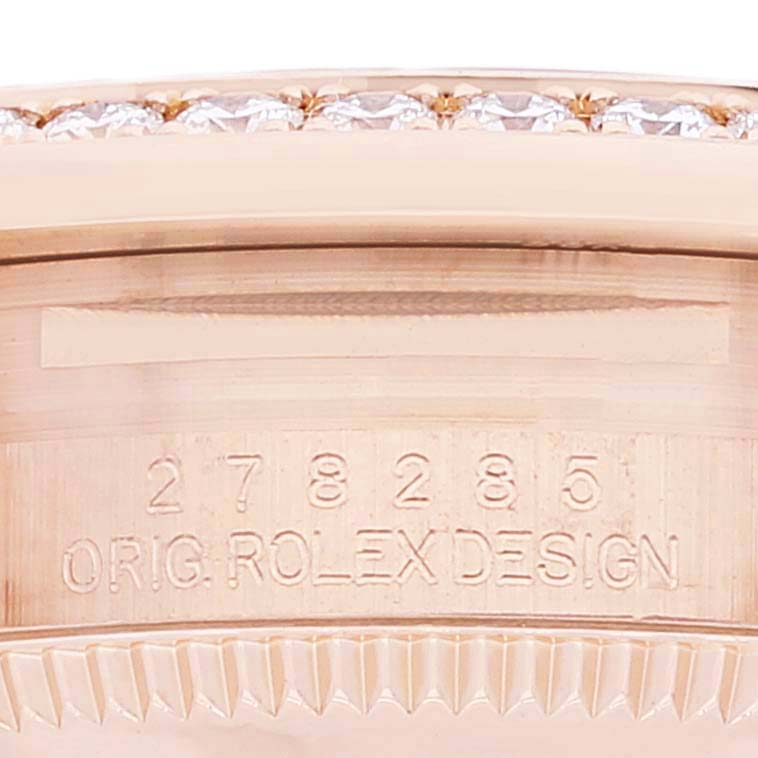 Close-up of the side of a Rolex President 278285 Women's Rose Gold Brown Dial 278285 Women's Rose Gold Brown Dial model watch, showing the serial number and part of the bezel.
