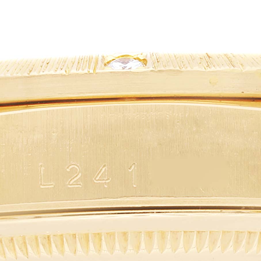 This is a close-up of the case and bezel, with a diamond detail and part of the serial number, on a Rolex President 18308 Men's Yellow Gold Champagne Dial 18308 Men's Yellow Gold Champagne Dial model watch.