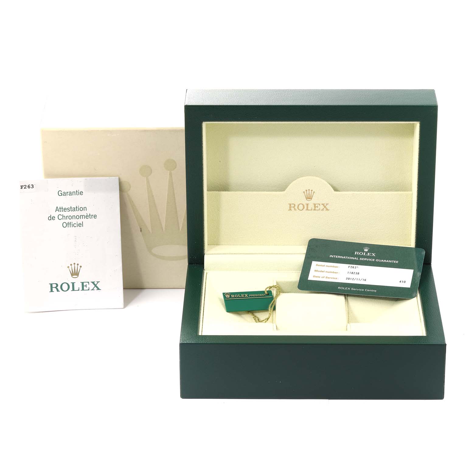 The image shows an open Rolex President 118238 Men
s Yellow Gold Champagne Dial 118238 Men
s Yellow Gold Champagne Dial watch box, paperwork, tags, and international service guarantee card.