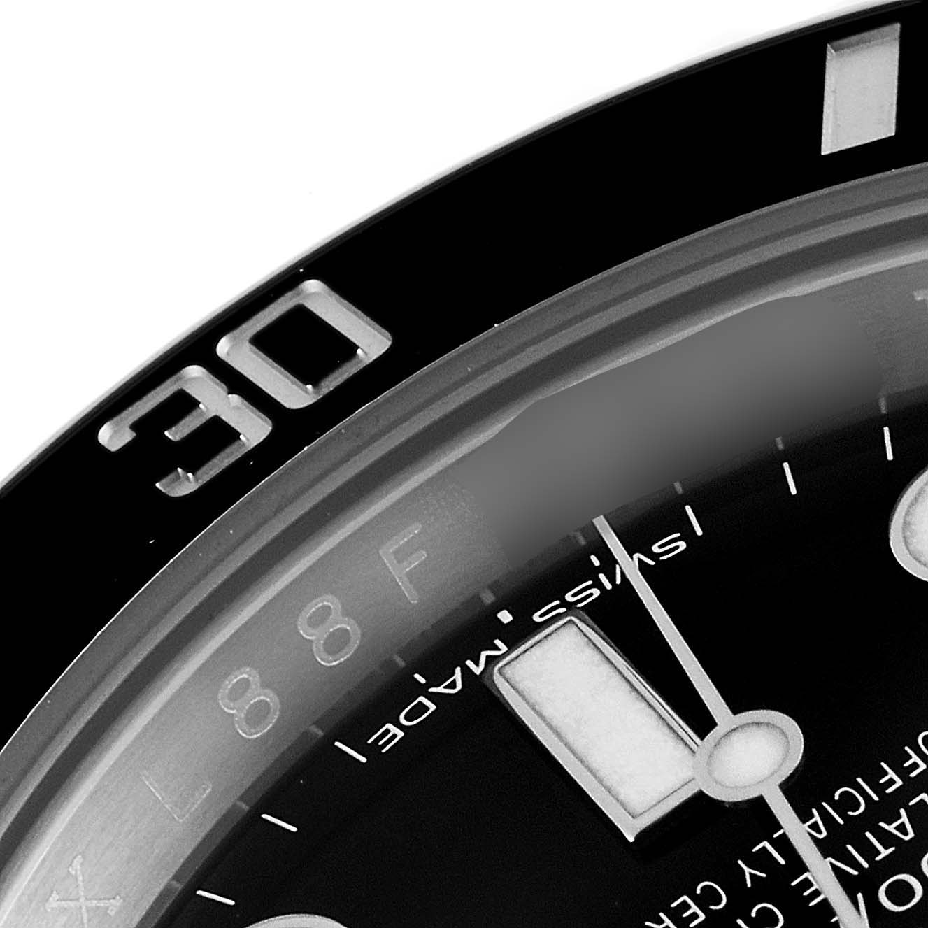 This close-up shot of a Rolex Submariner 114060 Men
s Stainless Steel Black Dial 114060 Men
s Stainless Steel Black Dial watch shows the bezel with the "30" mark and part of the dial with indices.