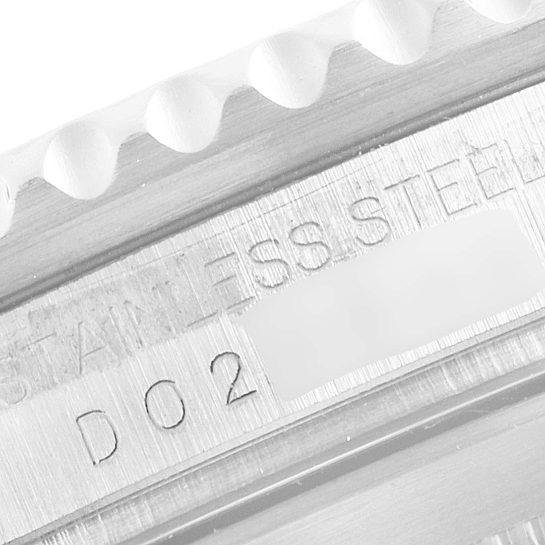 This close-up image shows the engraved text and part of the stainless steel bezel of a Rolex Submariner 16610 Men
s Stainless Steel Black Dial 16610 Men
s Stainless Steel Black Dial watch.