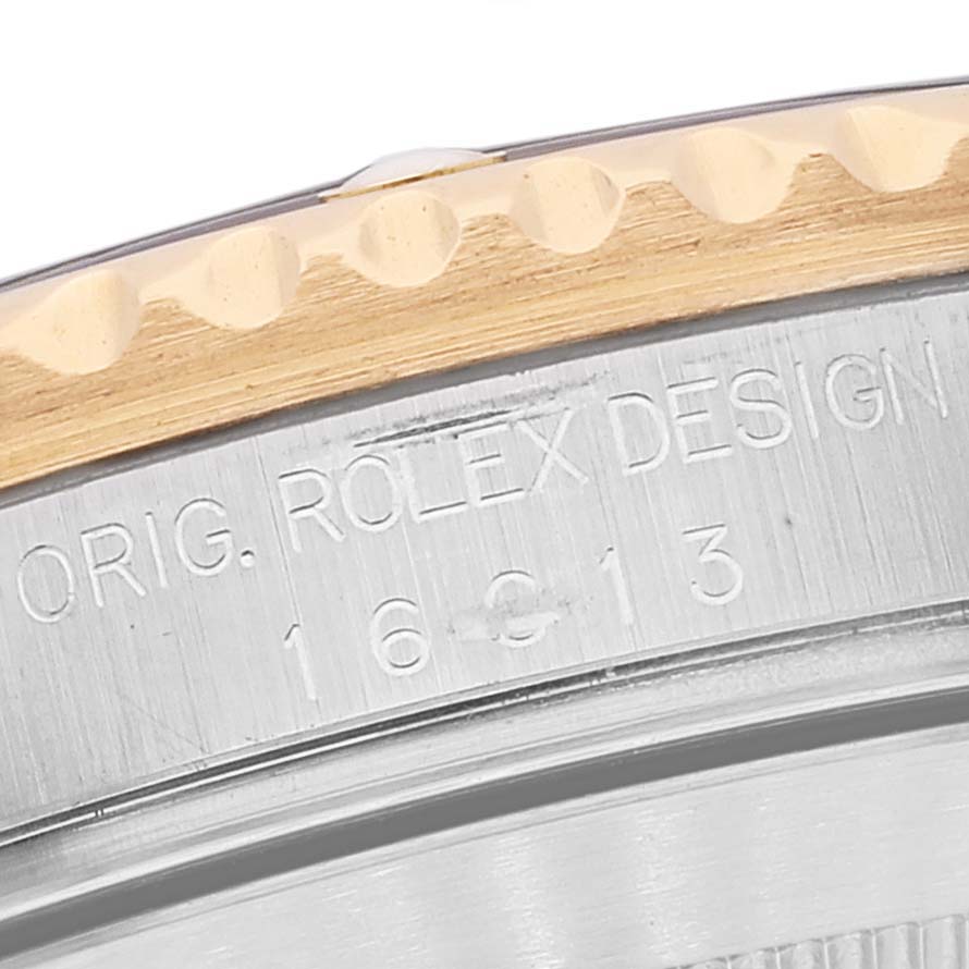 This close-up image shows the side of the bezel and the engraved model number of a Rolex Submariner 16613 Men
s Steel and Gold (two tone) Grey Dial 16613 Men
s Steel and Gold (two tone) Grey Dial watch.