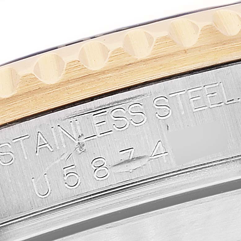 This image shows a close-up of the serial number engraving on the stainless steel case back of a Rolex Submariner 16613 Men
s Steel and Gold (two tone) Grey Dial 16613 Men
s Steel and Gold (two tone) Grey Dial watch.
