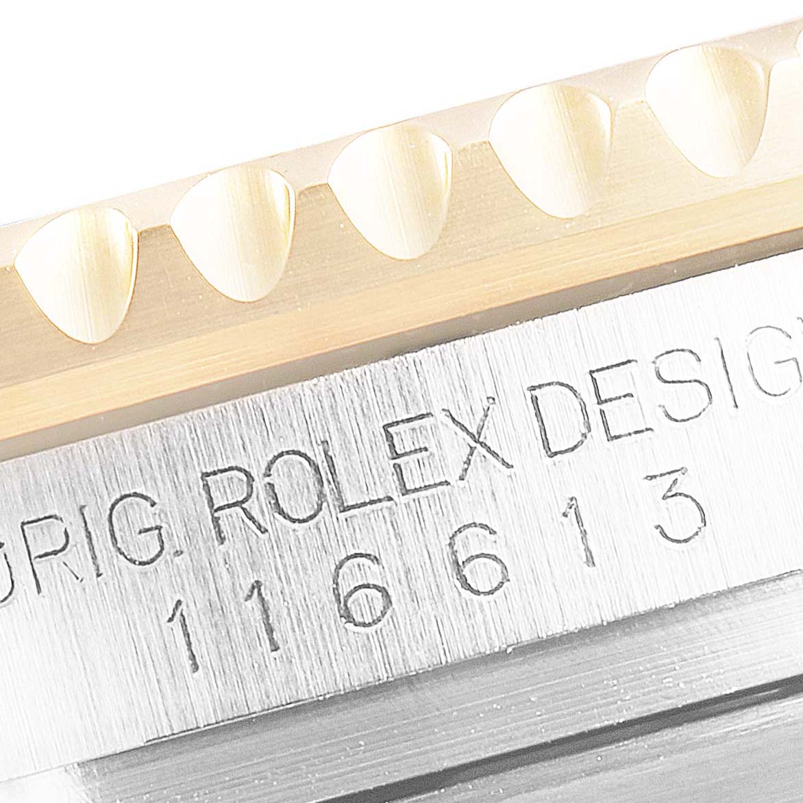 This image shows a close-up of the bezel and case side of a Rolex Submariner 116613 Men's Steel and Gold (two tone) Black Dial 116613 Men's Steel and Gold (two tone) Black Dial watch, highlighting the engraved model number.
