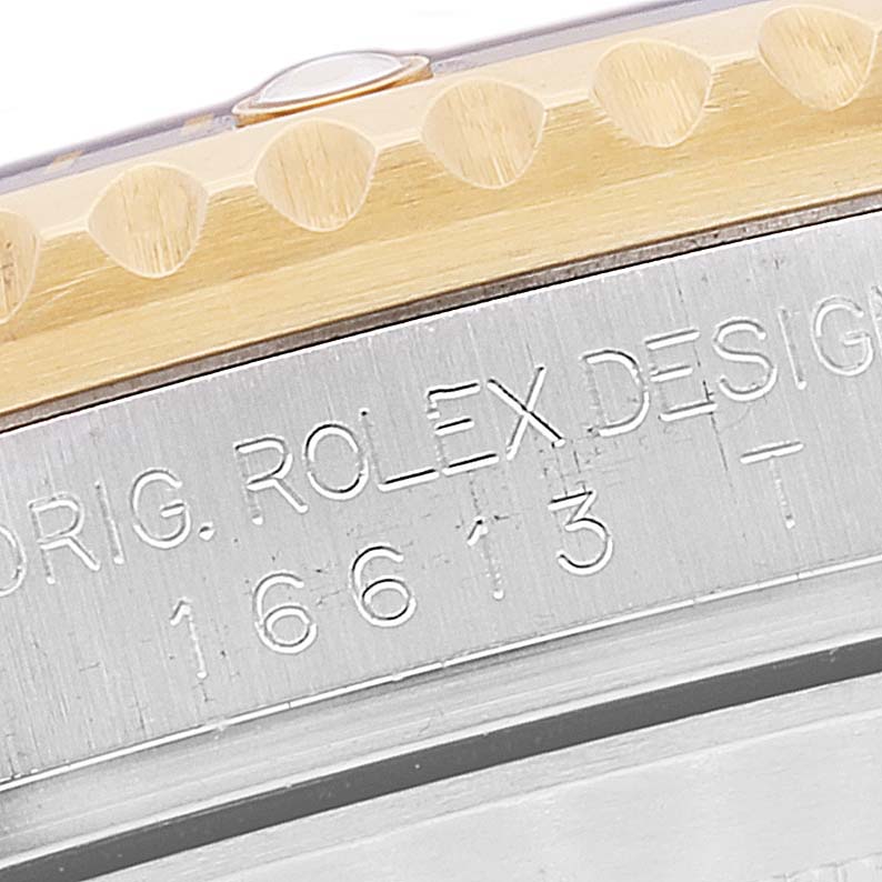 This close-up image shows the engraved case side and partial bezel of a Rolex Submariner 16613 Men's Steel and Gold (two tone) Blue Dial 16613 Men's Steel and Gold (two tone) Blue Dial watch, model number 16613.