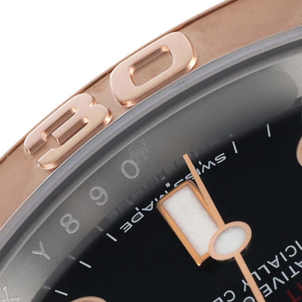 The image shows a close-up of the Rolex Yacht-Master 116621 Men
s Steel and Gold (two tone) Black Dial 116621 Men
s Steel and Gold (two tone) Black Dial model, focusing on the bezel, part of the dial, and a hand.