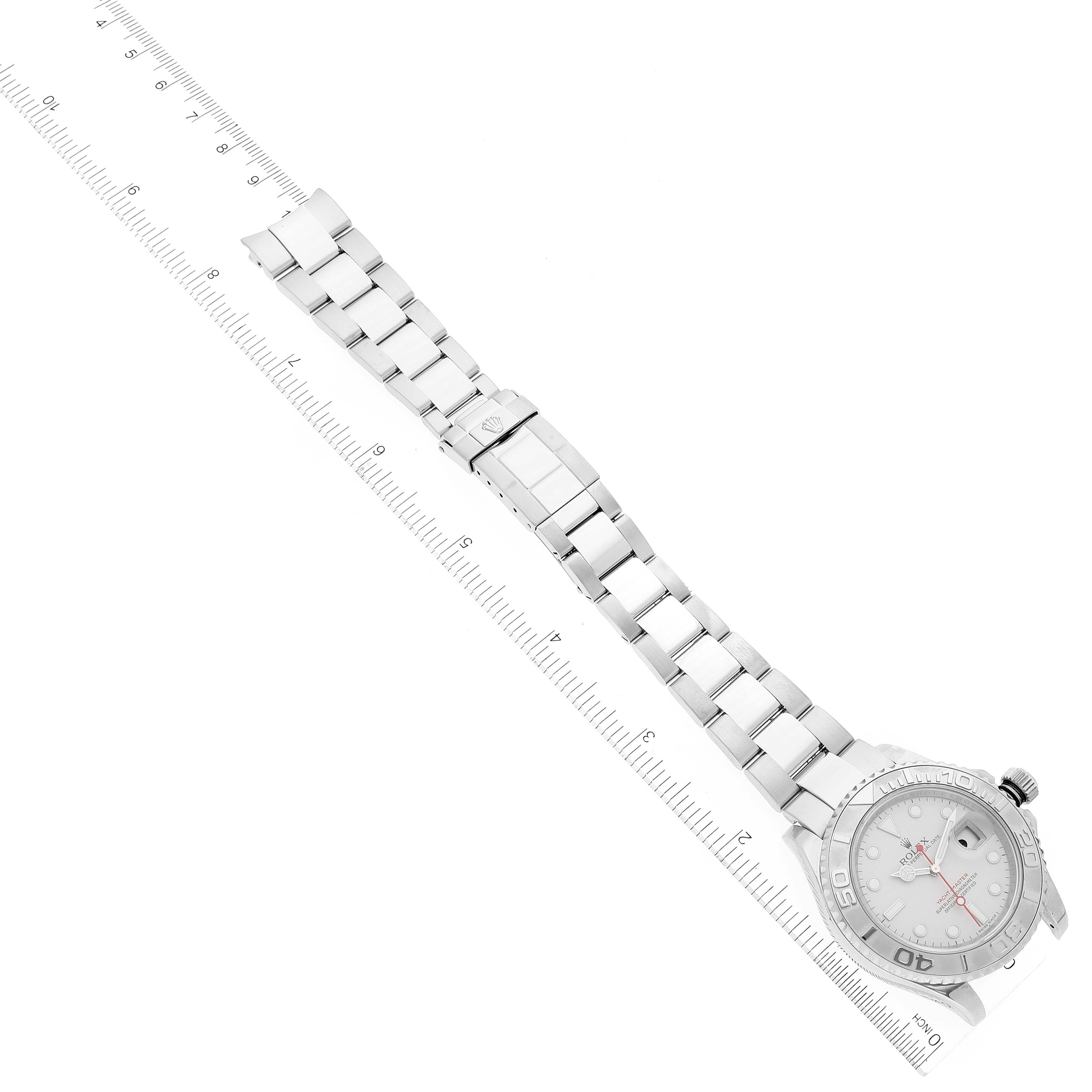 The image shows a top-down view of the Rolex Yacht-Master 16622 Men's Stainless Steel Silver Dial 16622 Men's Stainless Steel Silver Dial watch with the bezel, dial, crown, and bracelet visible, along with a ruler for scale.