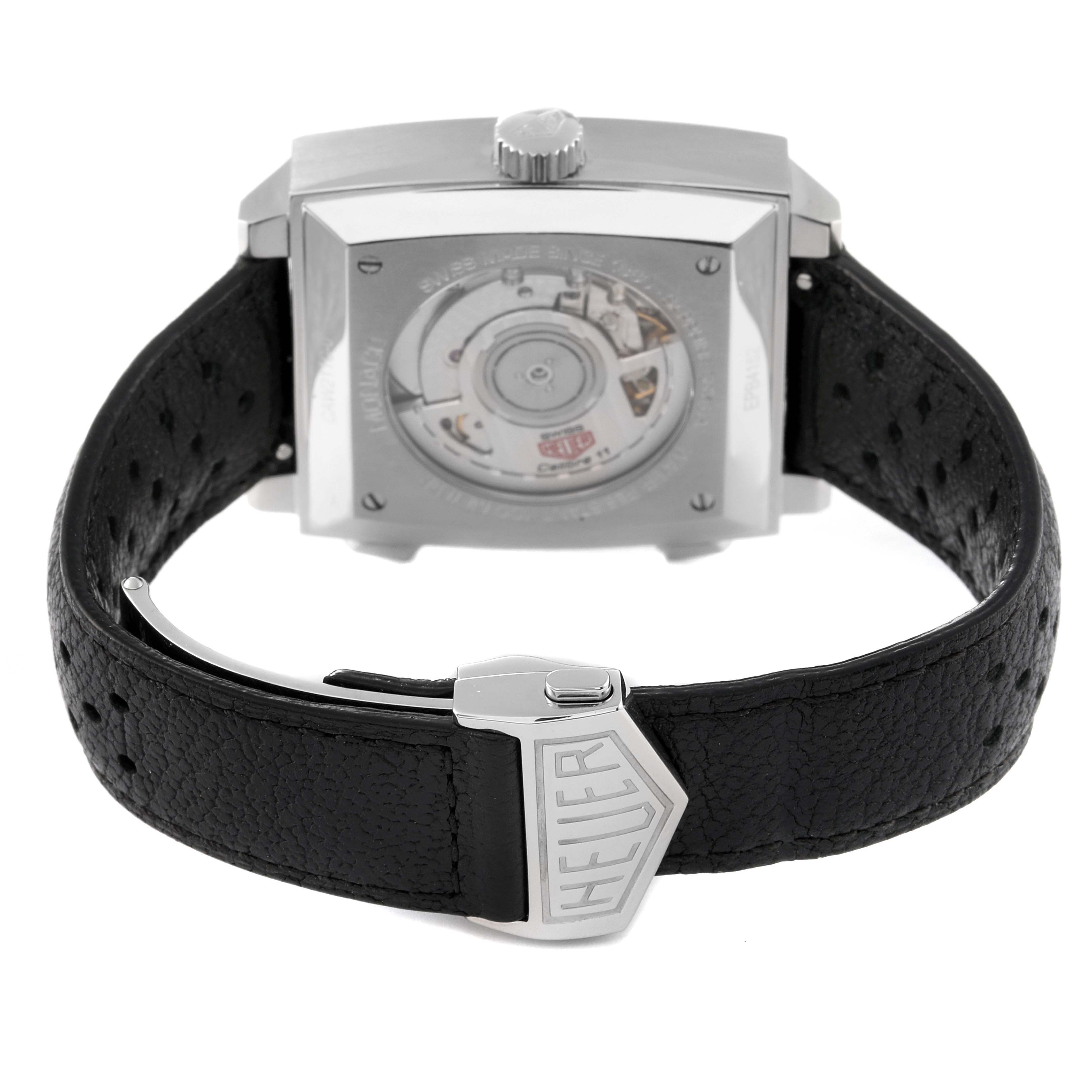 The image shows the back view of a Tag Heuer Monaco watch, highlighting its leather strap and deployment clasp.