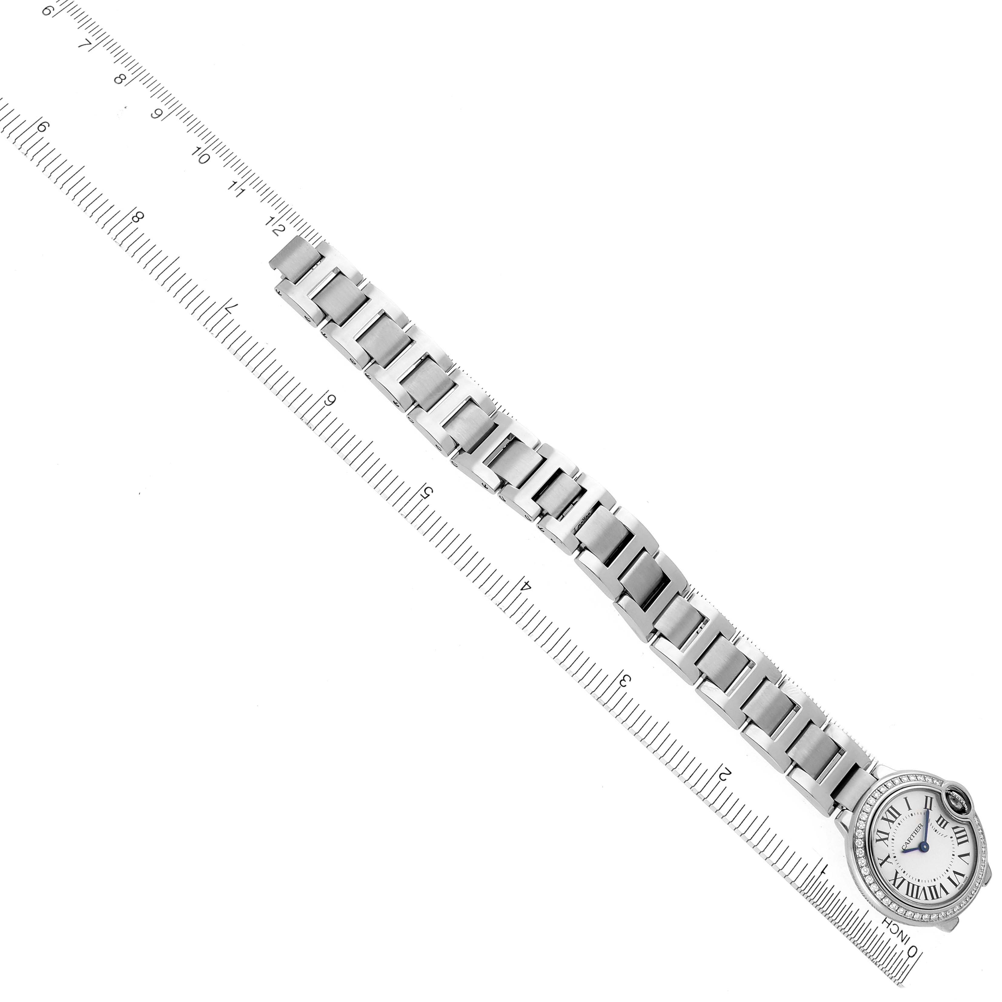 The Cartier Ballon Bleu W4BB0015 Women
s Stainless Steel Silver Dial W4BB0015 Women
s Stainless Steel Silver Dial watch is shown from a top-down angle with its full bracelet and face visible alongside a ruler.