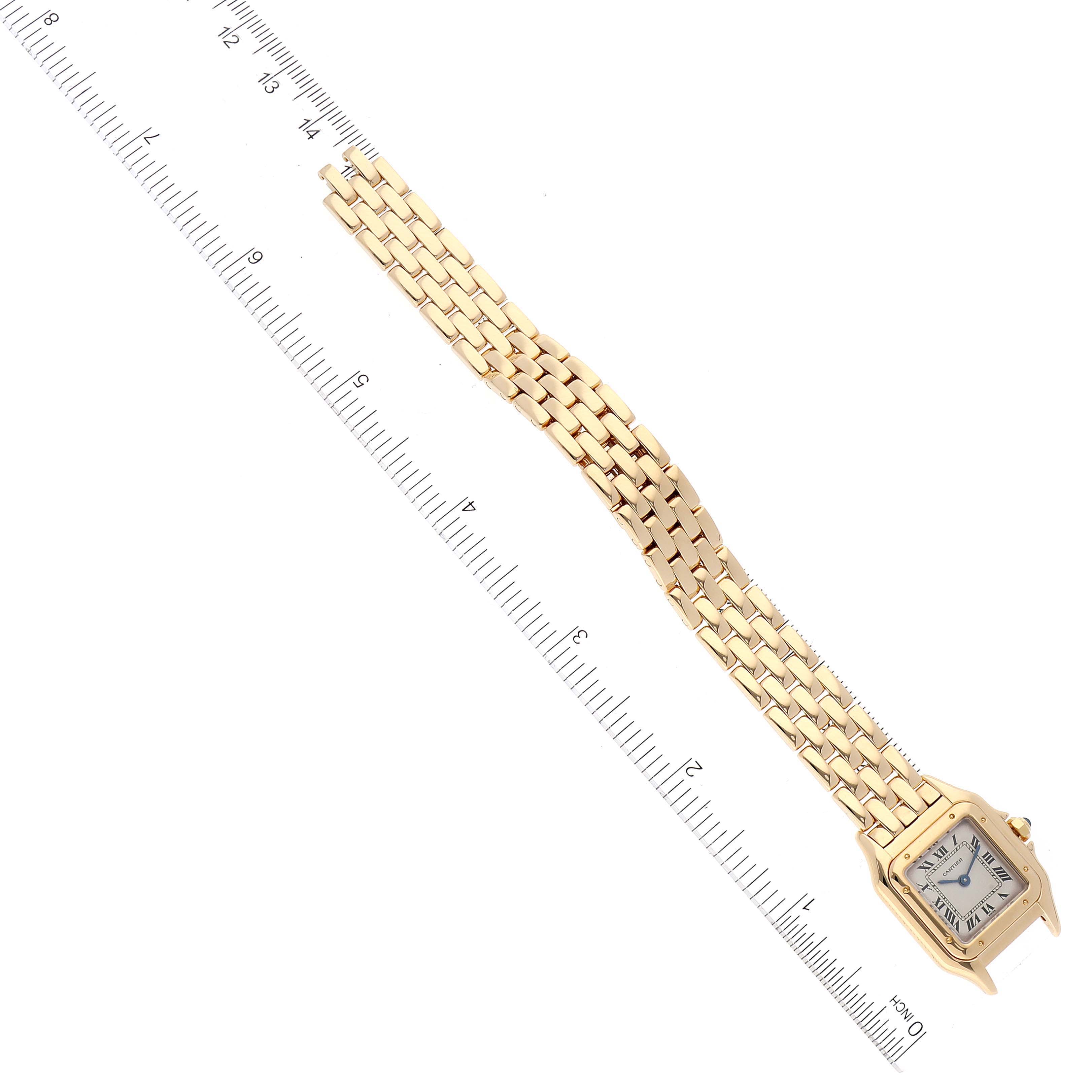 The Cartier Panthere W25022B9 Women's Yellow Gold Silver Dial W25022B9 Women's Yellow Gold Silver Dial model watch is shown from a top-down angle, displaying the face and entire bracelet next to a ruler.