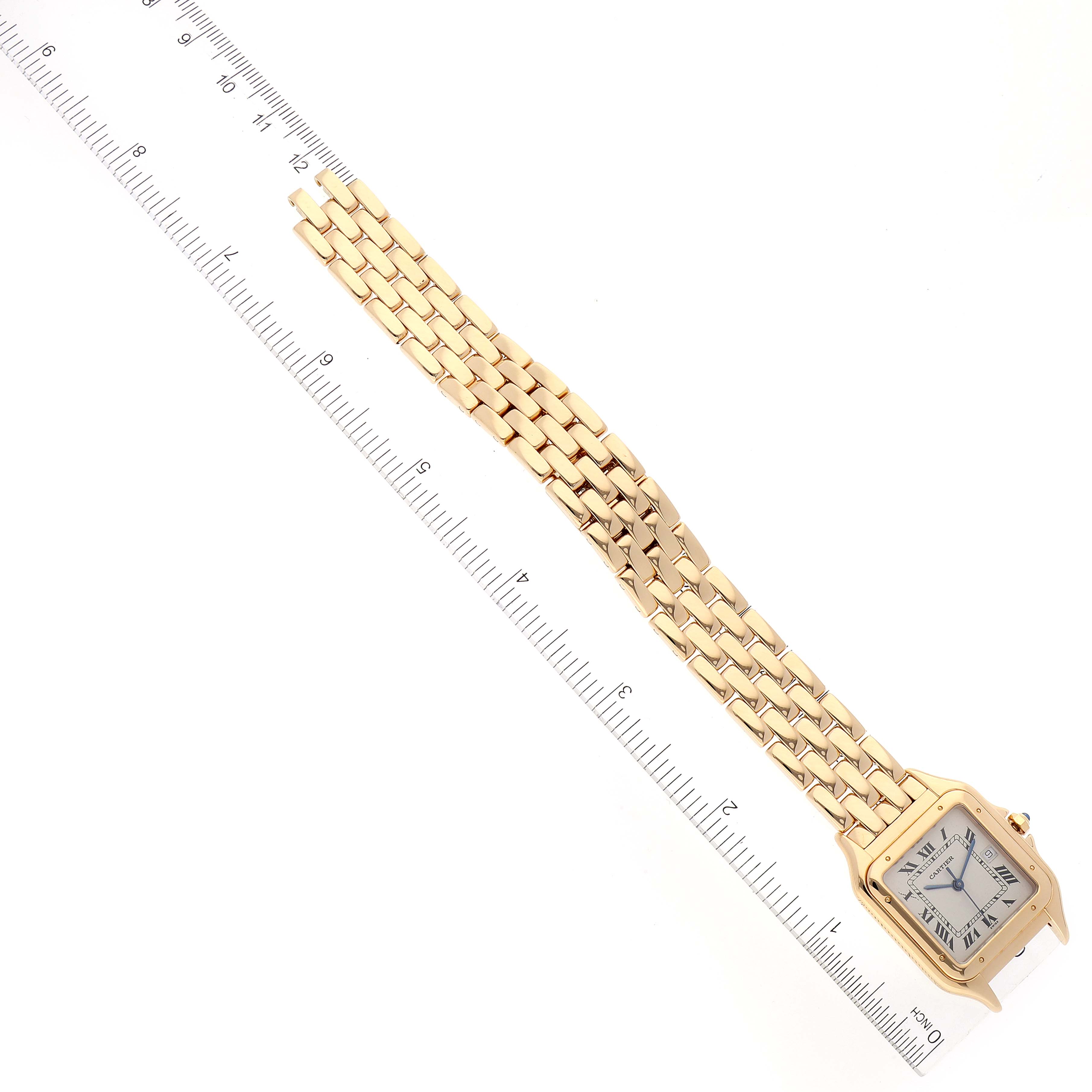 The Cartier Panthère watch is shown from a top-down view alongside a ruler for scale.