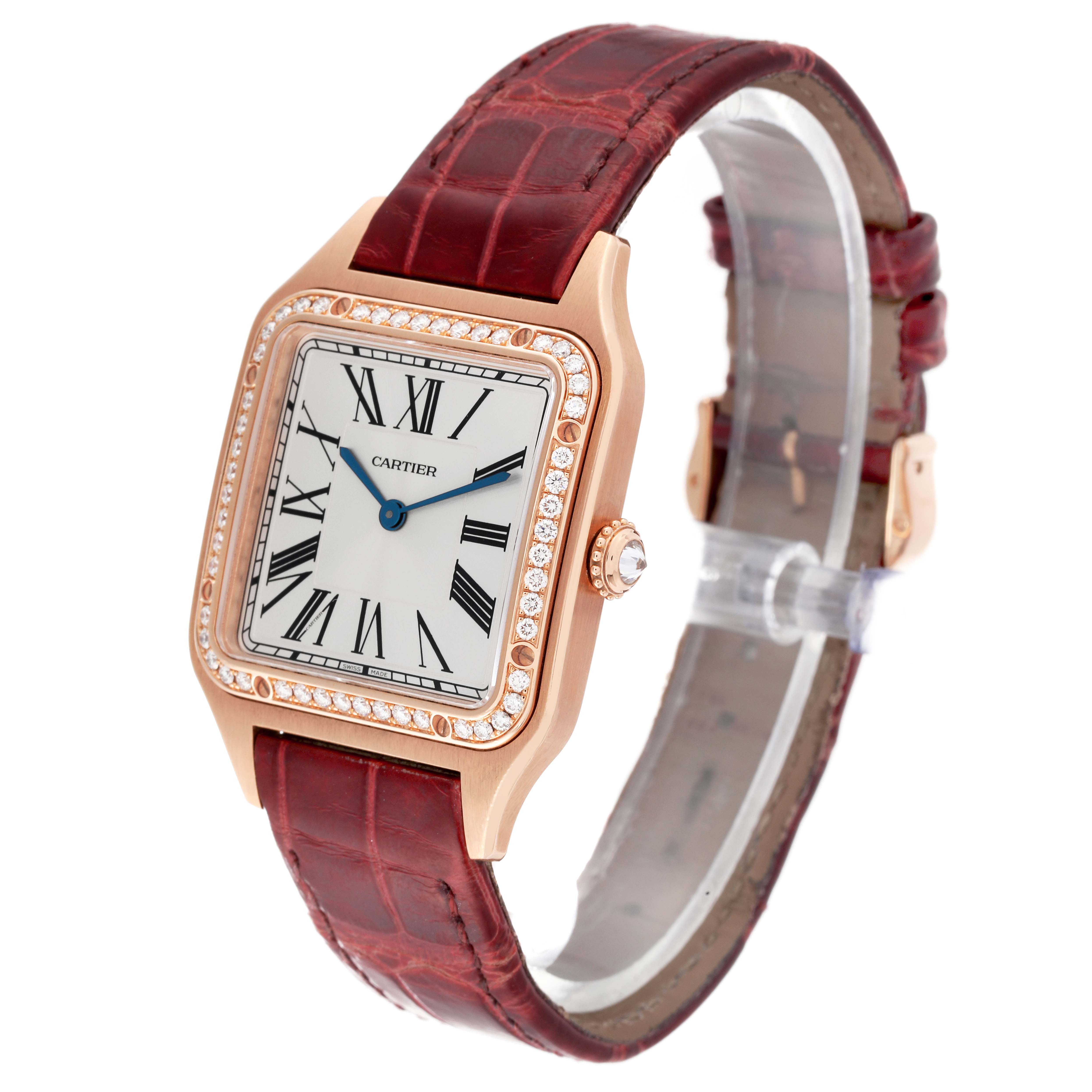 The Cartier Santos WJSA0016 Women's Rose Gold Silver Dial WJSA0016 Women's Rose Gold Silver Dial watch is shown at an oblique angle, highlighting its face, bezel, and leather strap.