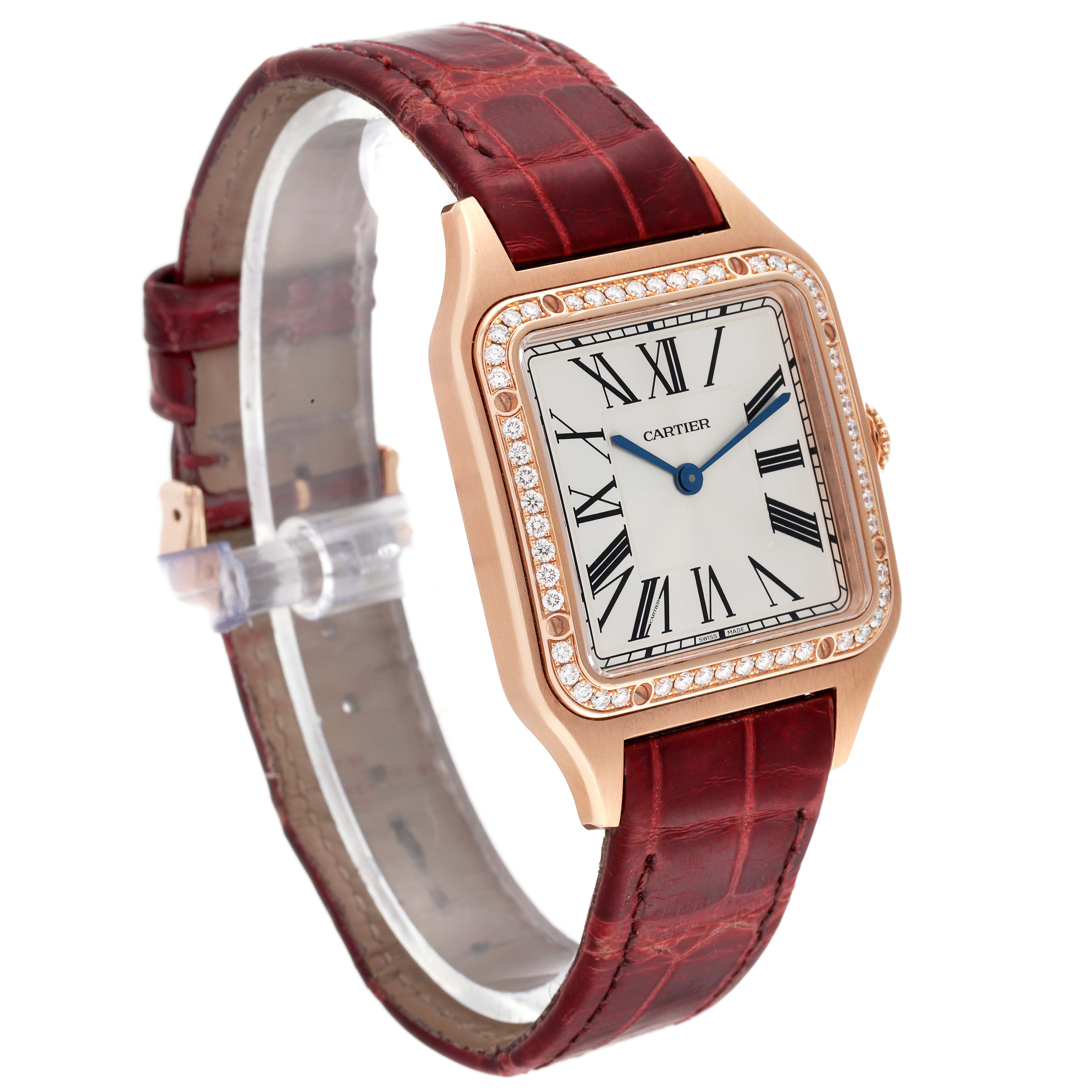 The Cartier Santos WJSA0016 Women's Rose Gold Silver Dial WJSA0016 Women's Rose Gold Silver Dial watch is shown at an angle highlighting its front face with a diamond-studded bezel and brown leather strap.