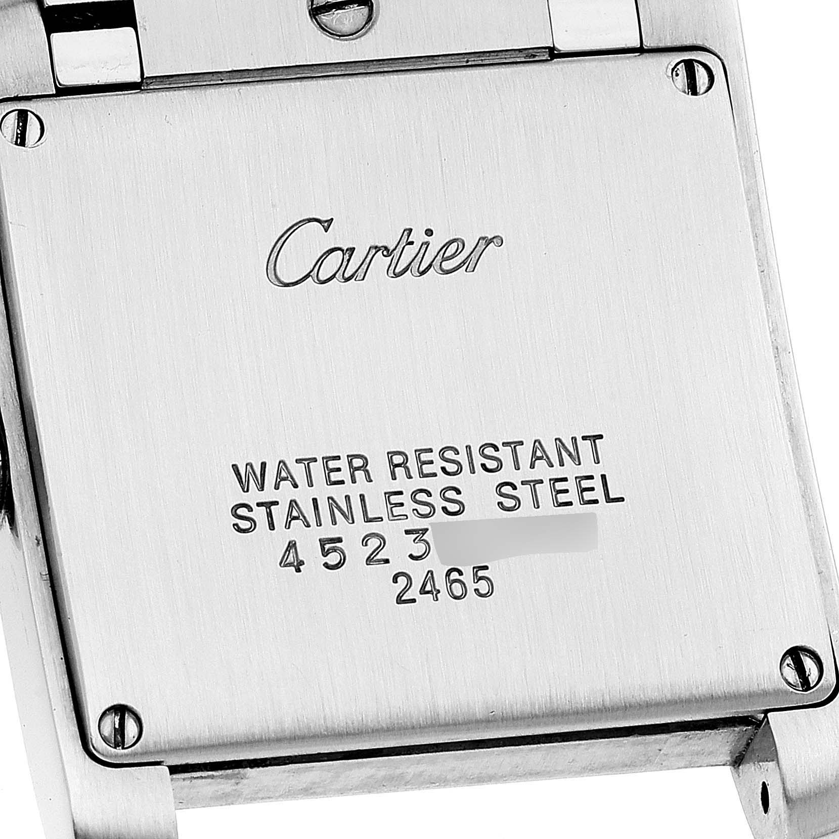 This image shows the back casing of a Cartier Tank Francaise W51012Q4 Women's Steel and Gold (two tone) Silver Dial W51012Q4 Women's Steel and Gold (two tone) Silver Dial watch, featuring engravings for water resistance and stainless steel.