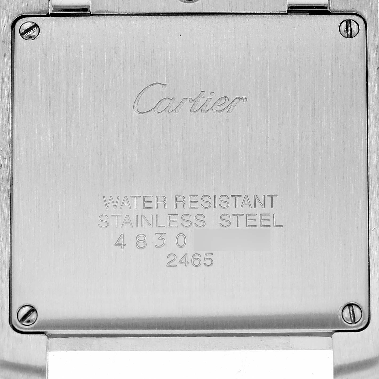 This is an image of the back casing of a Cartier Tank Francaise W51012Q4 Women
s Steel and Gold (two tone) Silver Dial W51012Q4 Women
s Steel and Gold (two tone) Silver Dial watch, displaying its engravings and screws.