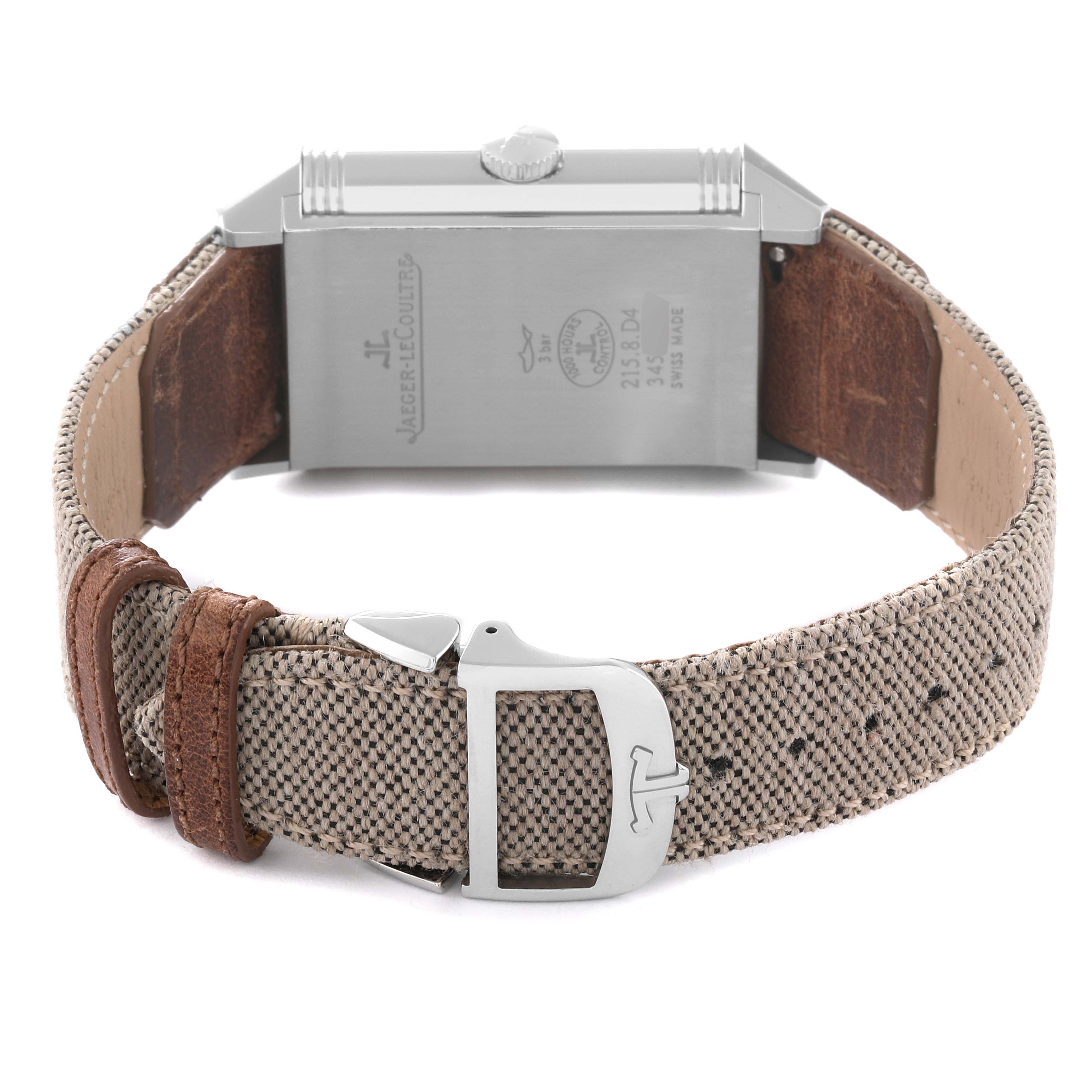 The image shows the back view of the Jaeger LeCoultre Reverso 215.8.D4 Q3848422 Men's Stainless Steel Silver Dial 215.8.D4 Q3848422 Men's Stainless Steel Silver Dial watch, highlighting its case, crown, and fabric strap with a buckle.