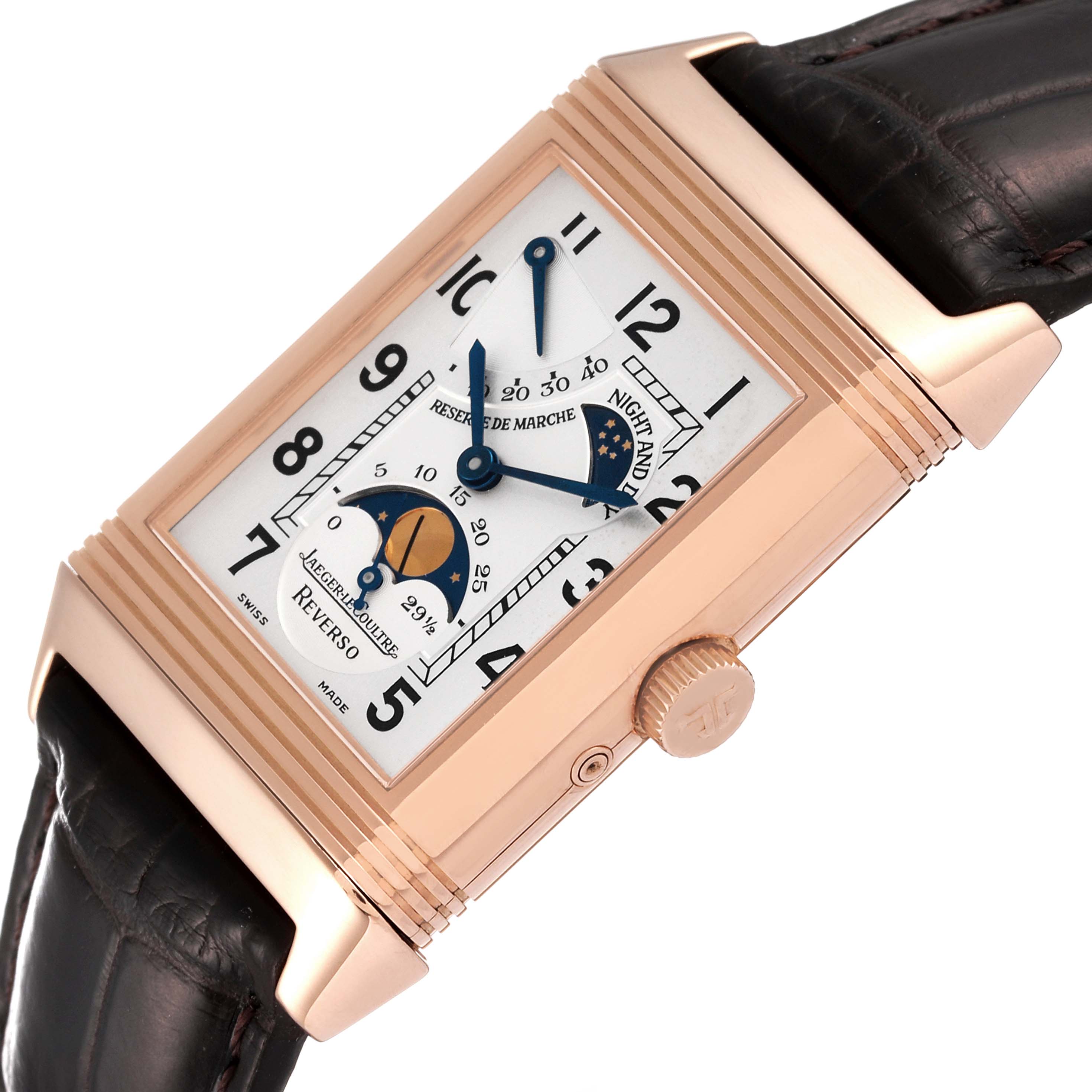The Jaeger-LeCoultre Reverso watch is shown at an angled view, highlighting the rectangular dial and brown leather strap.