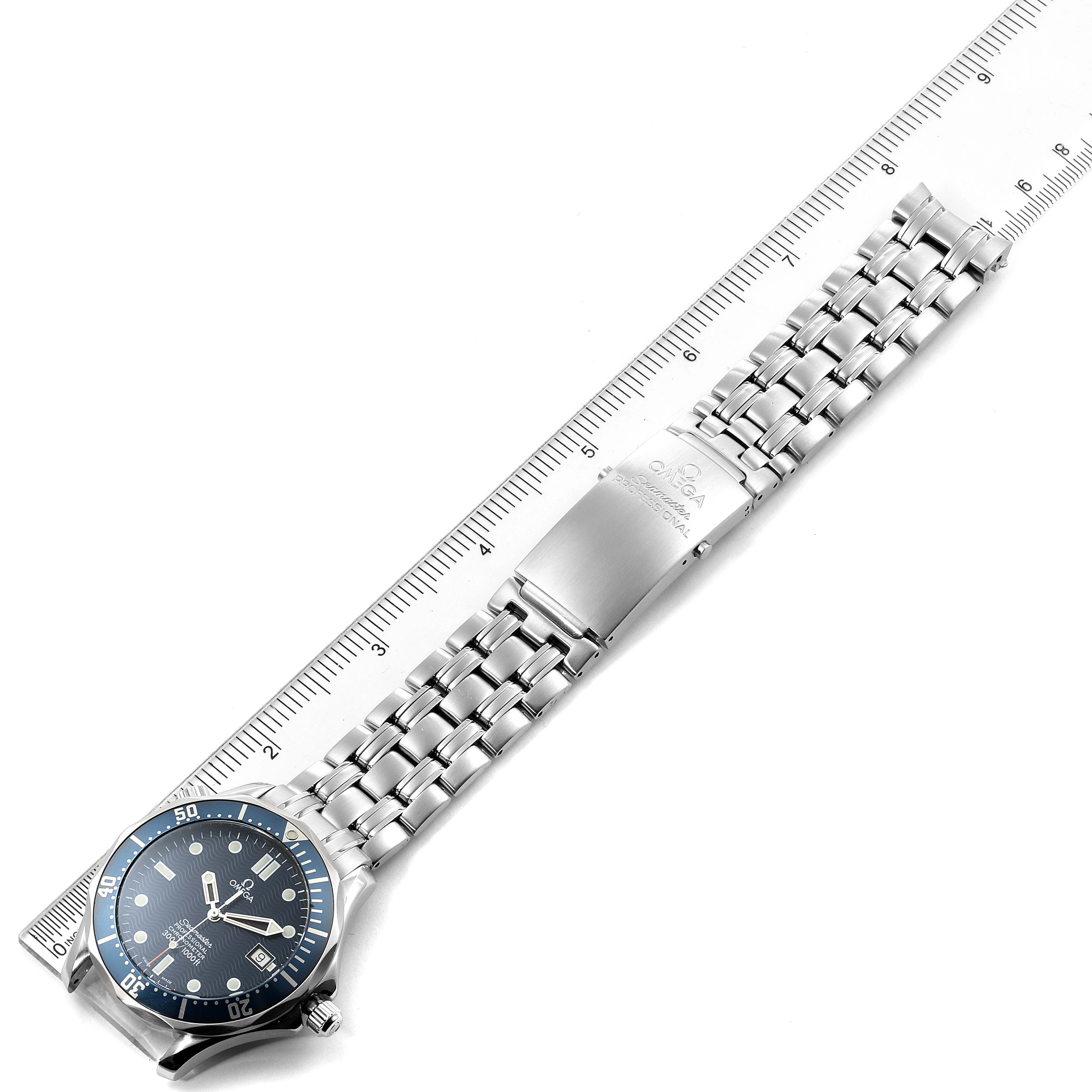 The Omega Seamaster 2531.80.00 Men
s Stainless Steel Blue Dial 2531.80.00 Men
s Stainless Steel Blue Dial watch is shown from a top-down angle, including its blue dial, bezel, and full metal bracelet, with a ruler for scale.