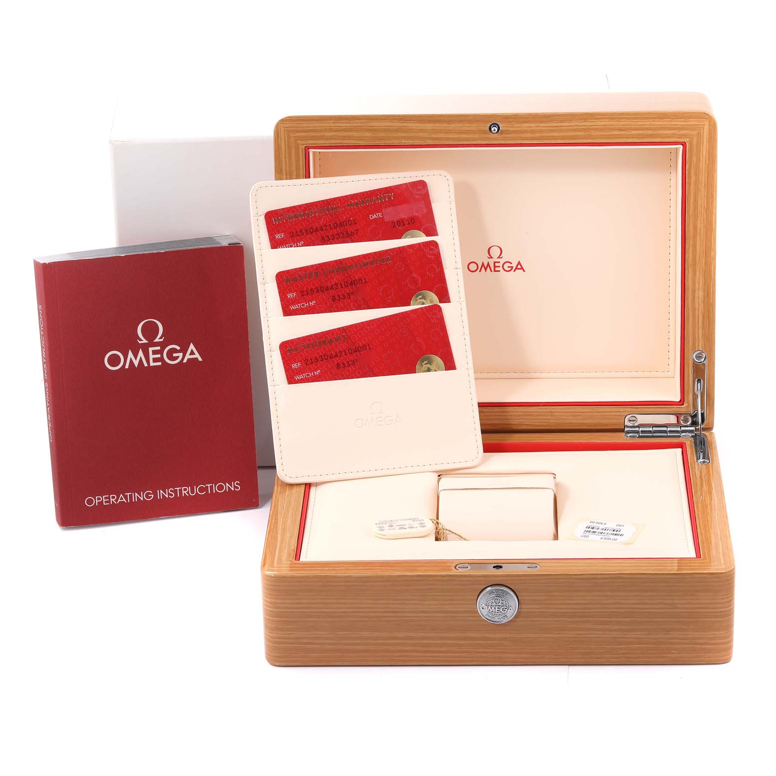 The image shows an Omega Planet Ocean 215.30.44.21.04.001 Men
s Stainless Steel White Dial 215.30.44.21.04.001 Men
s Stainless Steel White Dial watch box set with operating instructions, warranty cards, and the watch box viewed from above.