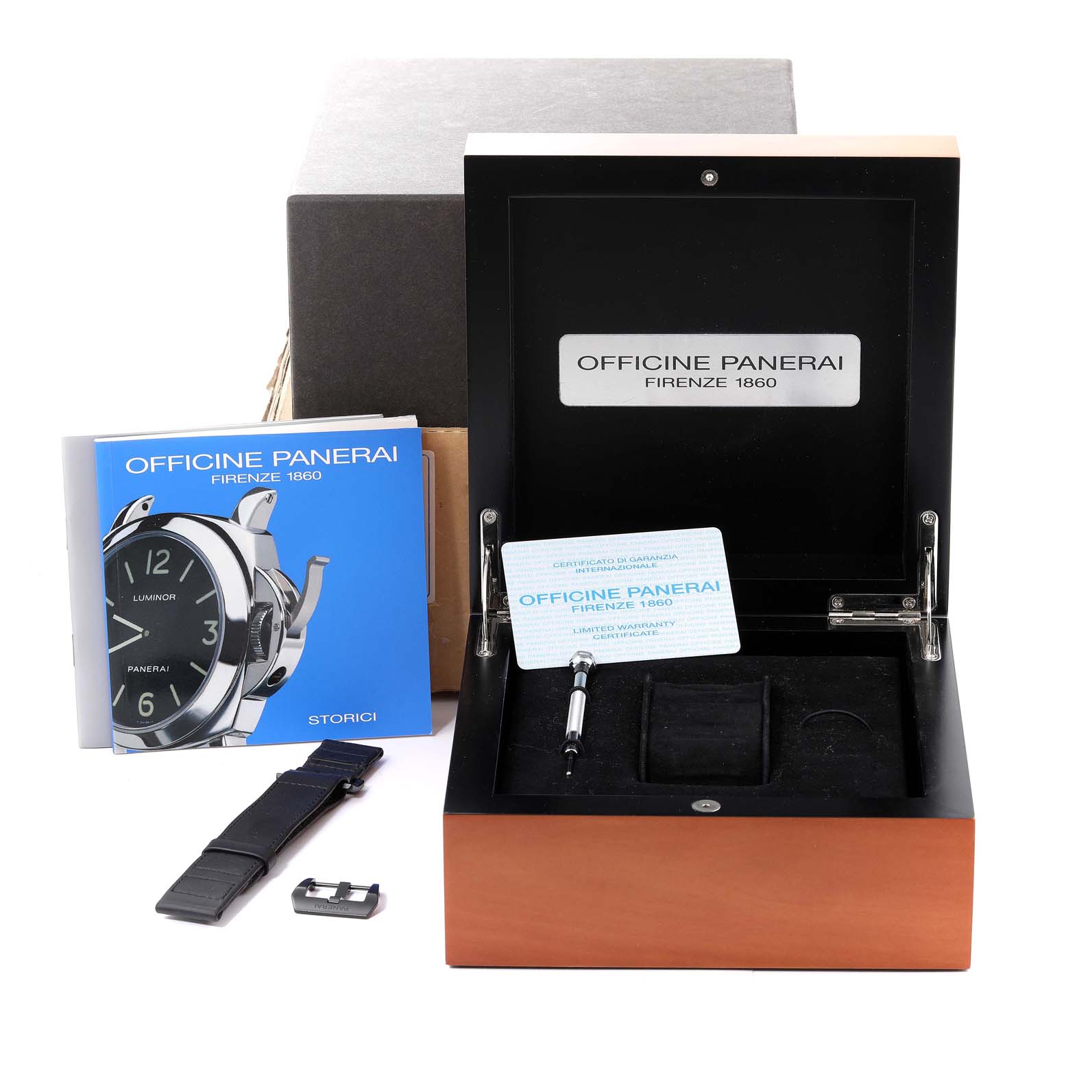 This image shows an open Panerai Luminor PAM00009 Men
s Stainless Steel Black Dial PAM00009 Men
s Stainless Steel Black Dial watch box with accessories including a strap, tool, booklet, and warranty card.