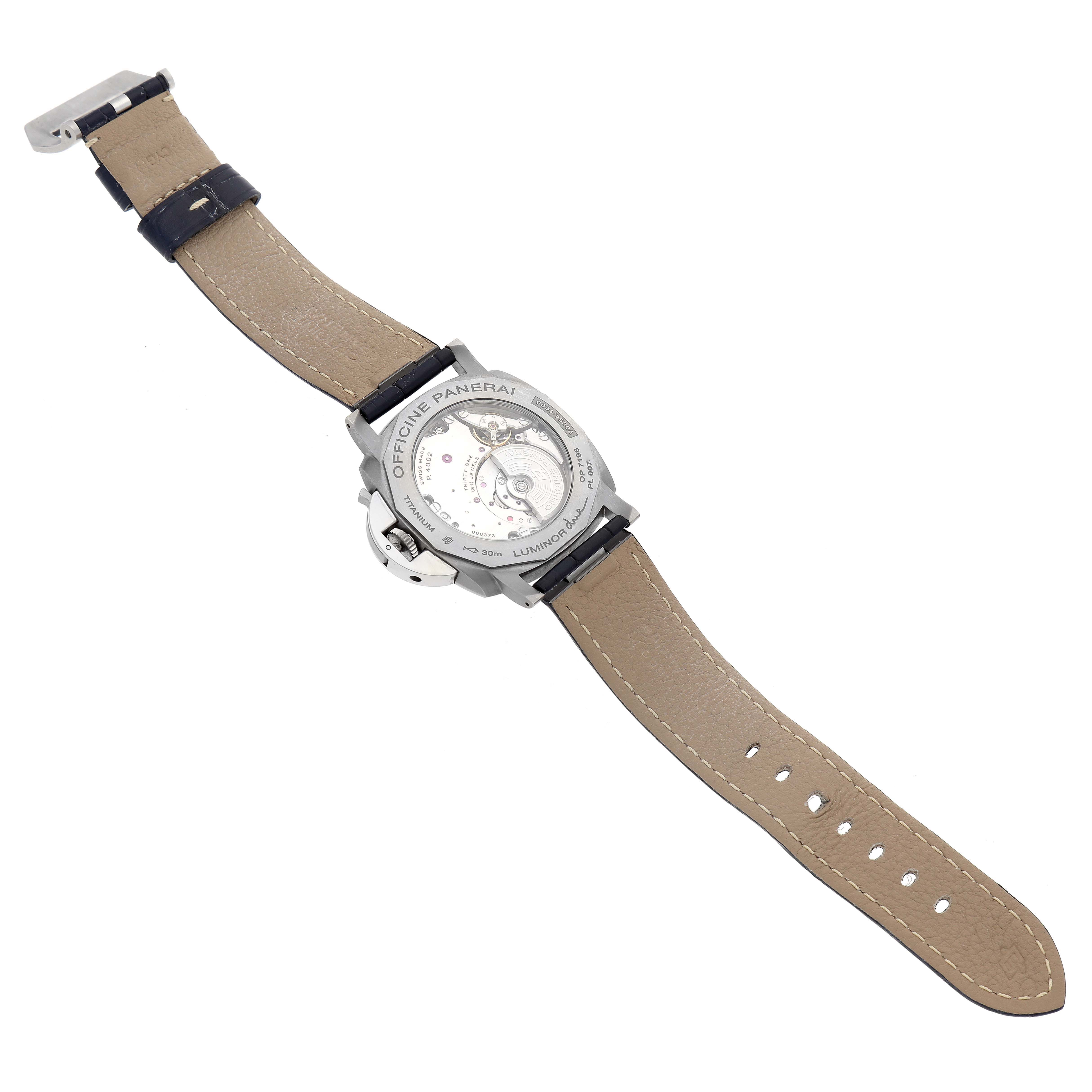 The image shows the underside and movement of a Panerai Luminor Due PAM00964 Men
s Titanium Blue Dial PAM00964 Men
s Titanium Blue Dial watch, focusing on the open case back and leather strap.