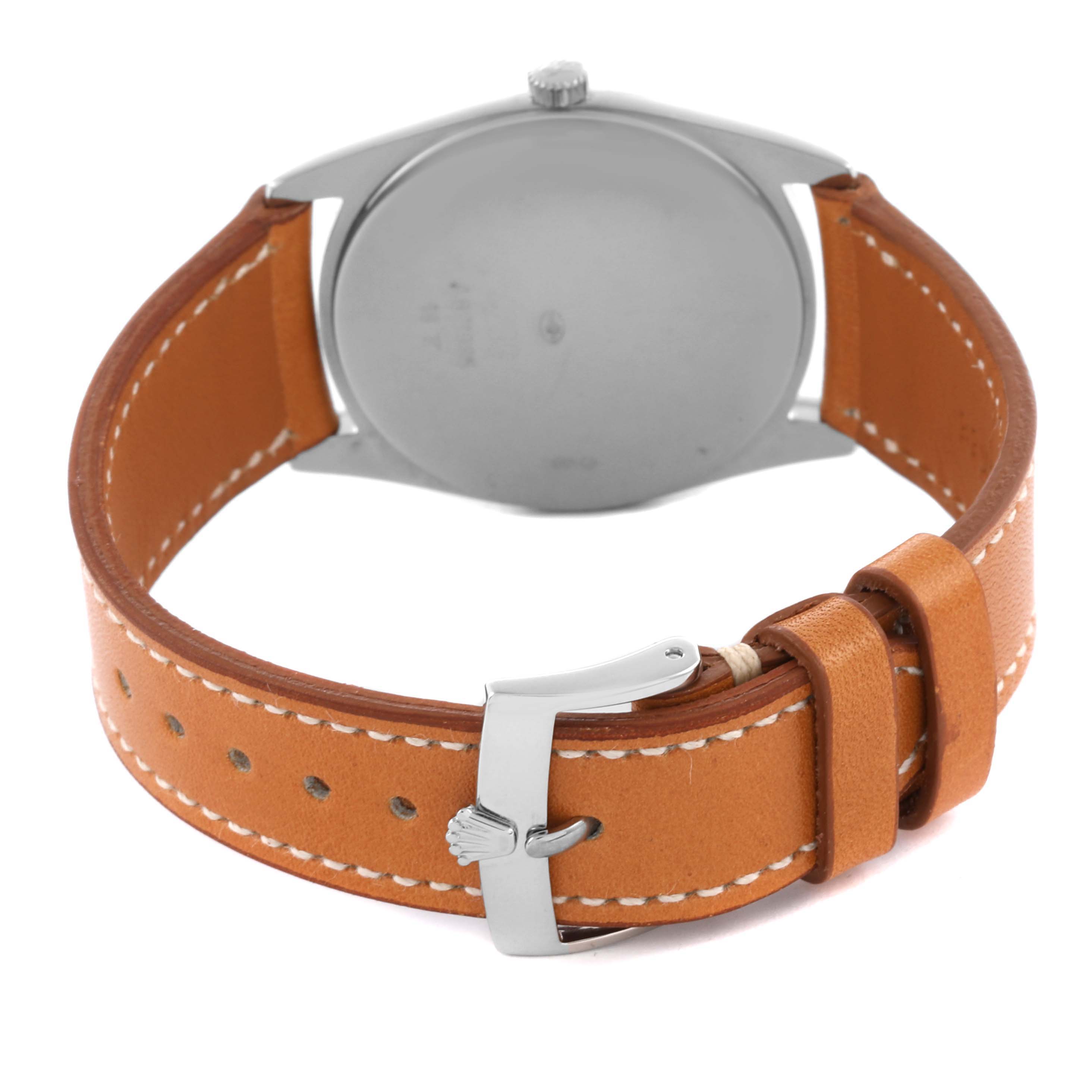 The Rolex Cellini 4233 Men's White Gold White Dial 4233 Men's White Gold White Dial watch is shown from the back, highlighting its caseback, brown leather strap, and buckle.