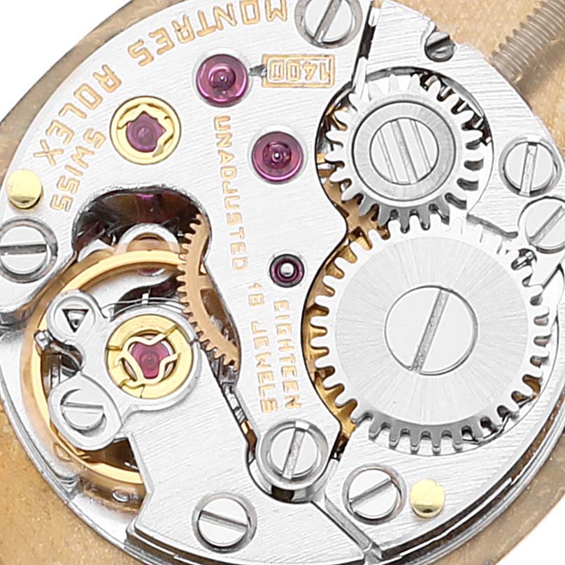 Close-up of a Rolex Cellini 2674 Women's Yellow Gold Champagne Dial 2674 Women's Yellow Gold Champagne Dial watch movement showing gears, jewels, and engravings.