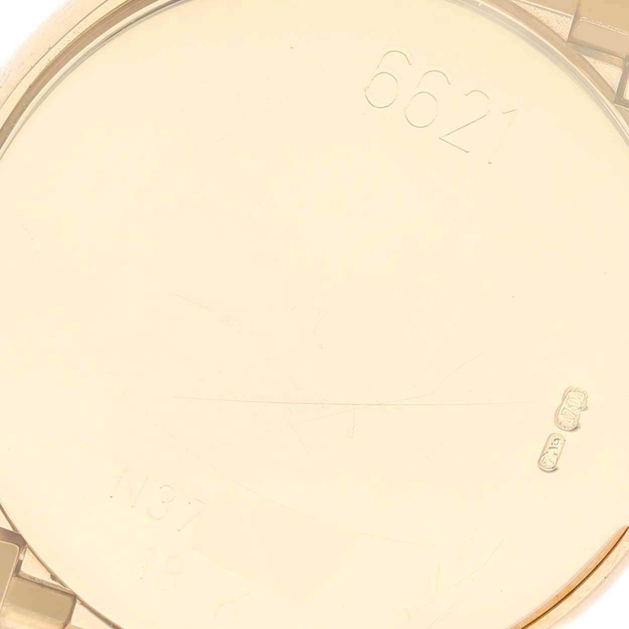 This image shows the inside case back of a Rolex Cellini 6621 Women's Yellow Gold Champagne Dial 6621 Women's Yellow Gold Champagne Dial watch, featuring some engraved markings.