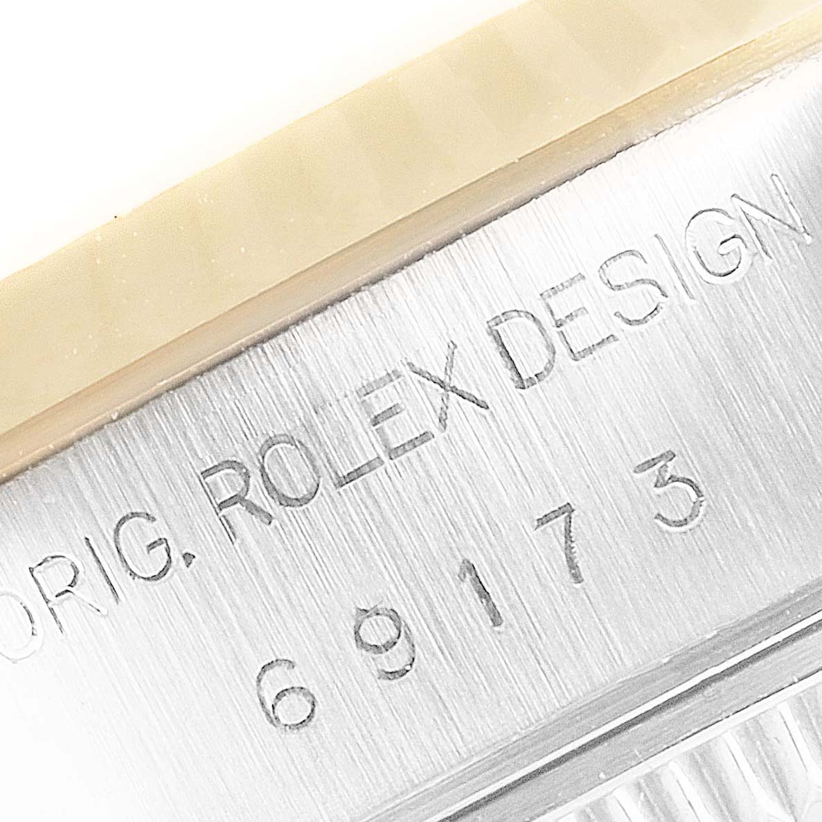 The image shows a close-up angle of the outer rim and engraving, including the model number, of a Rolex Datejust 69173 Women's Steel and Gold (two tone) Champagne Dial 69173 Women's Steel and Gold (two tone) Champagne Dial watch.