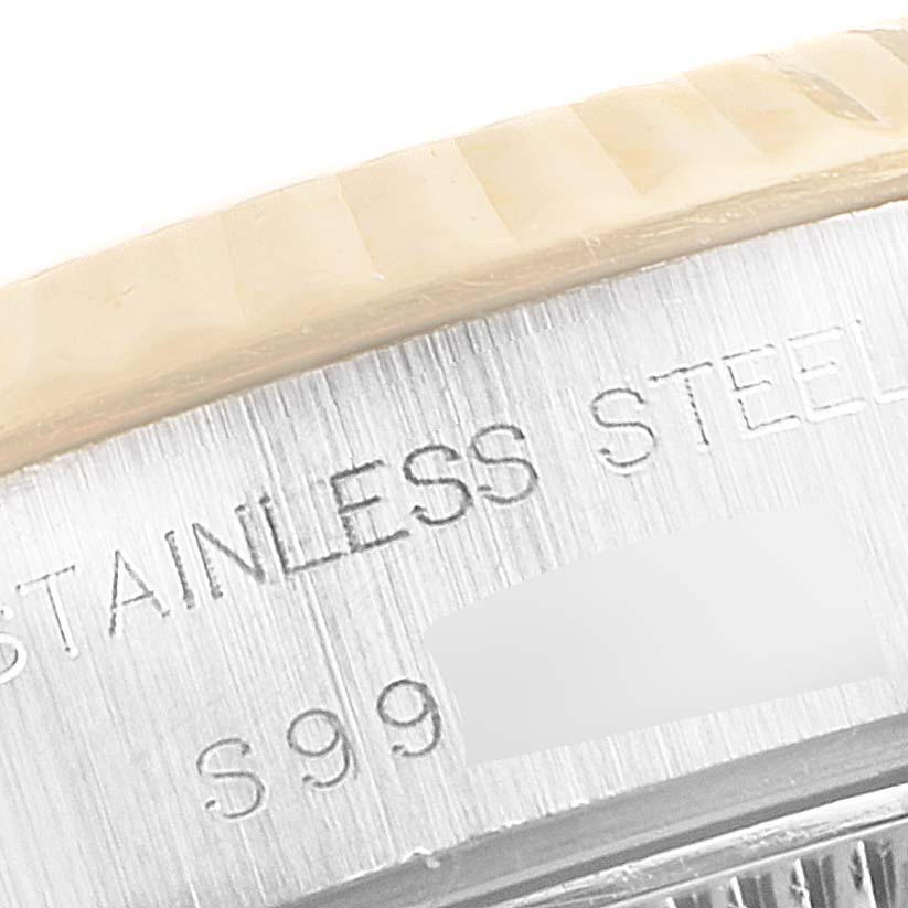 The image shows a close-up of the engraved stainless steel casing and part of the bezel of a Rolex Datejust 69173 Women's Steel and Gold (two tone) Champagne Dial 69173 Women's Steel and Gold (two tone) Champagne Dial watch.