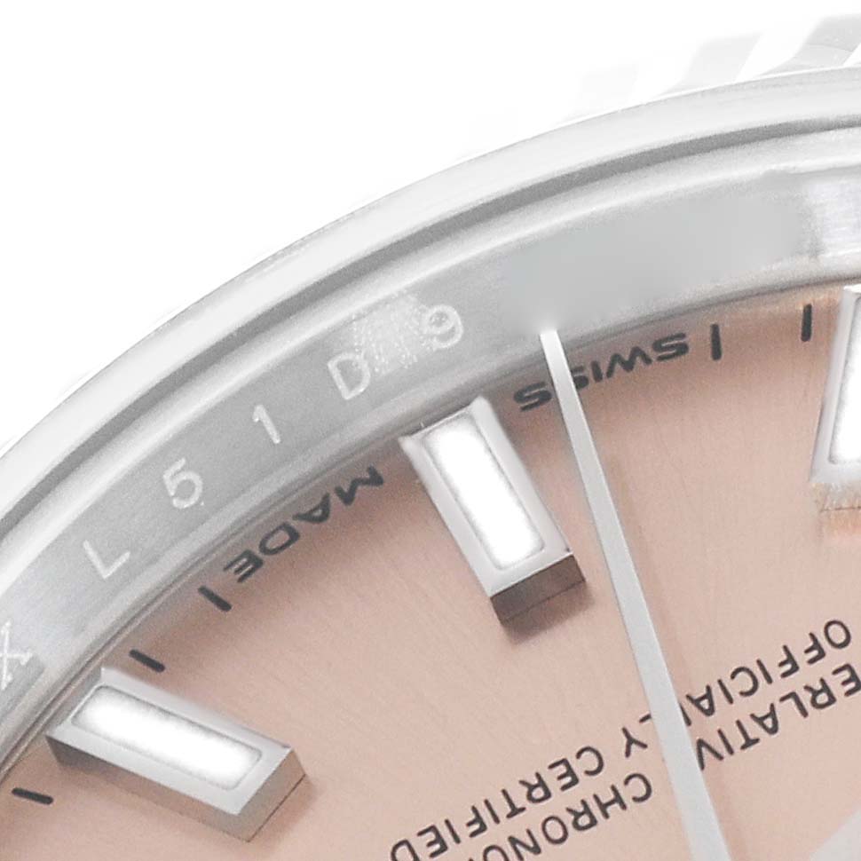 This image shows a close-up of the dial and bezel of a Rolex Datejust 279174 Women's Stainless Steel Pink Dial 279174 Women's Stainless Steel Pink Dial watch, highlighting the hour markers and part of the inscription.