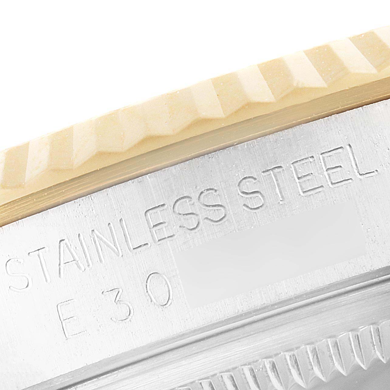 This close-up image shows the detailed fluted bezel and "STAINLESS STEEL" engraving on the case of a Rolex Datejust 16233 Men's Steel and Gold (two tone) Champagne Dial 16233 Men's Steel and Gold (two tone) Champagne Dial watch.