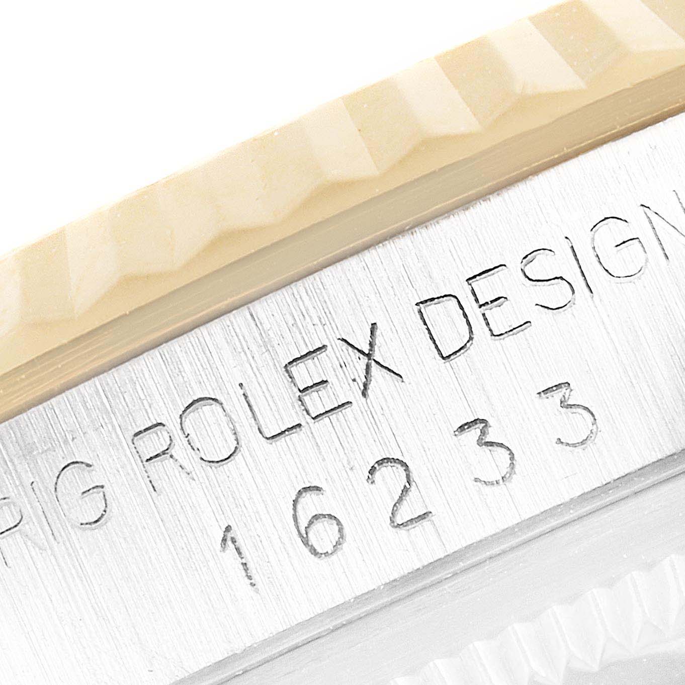 This close-up image shows the engraved model number and part of the fluted bezel of a Rolex Datejust 16233 Men's Steel and Gold (two tone) Champagne Dial 16233 Men's Steel and Gold (two tone) Champagne Dial watch.