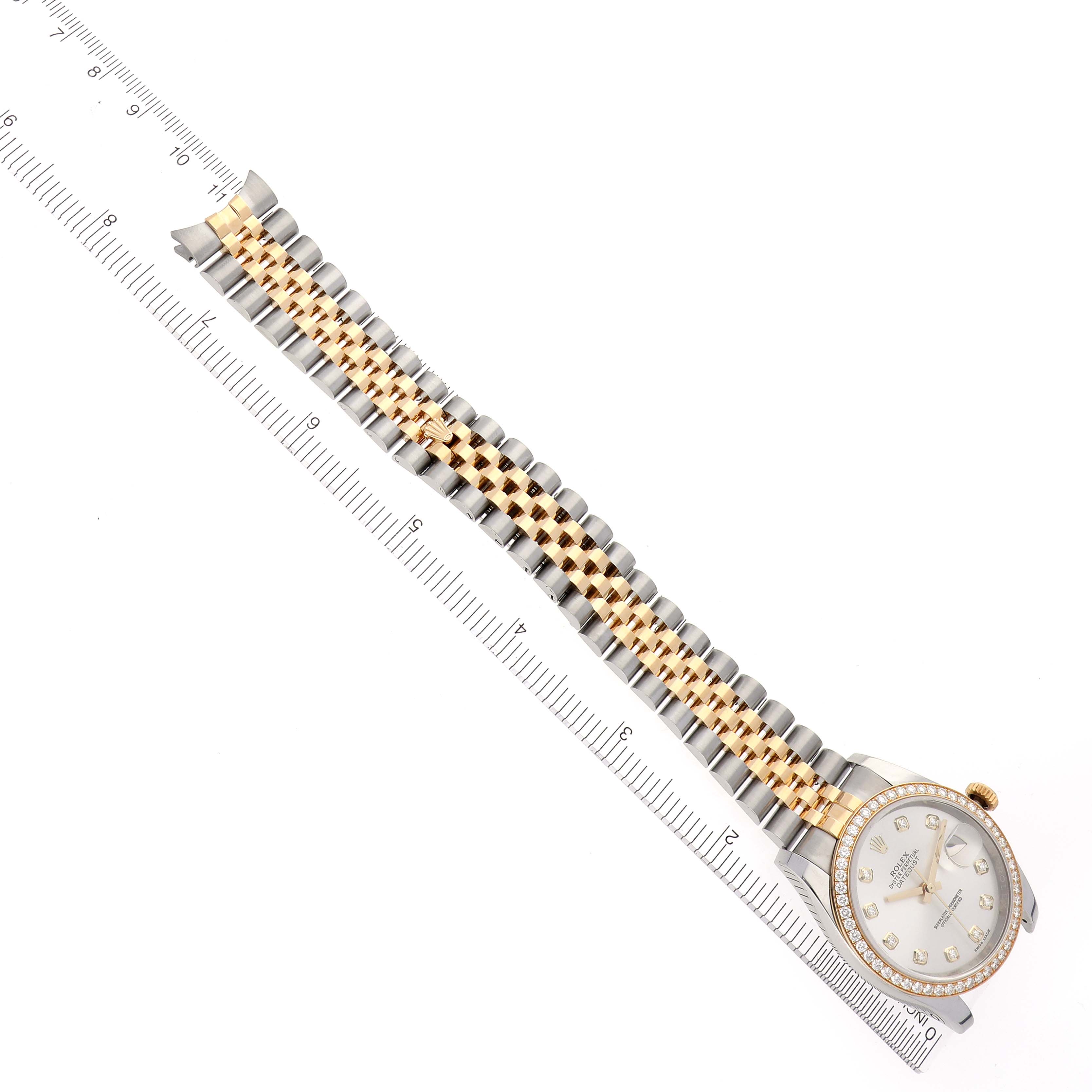 The Rolex Datejust 116243 Men
s Steel and Gold (two tone) Silver Dial 116243 Men
s Steel and Gold (two tone) Silver Dial watch is shown from a top-down angle, focusing on the bracelet and dial.