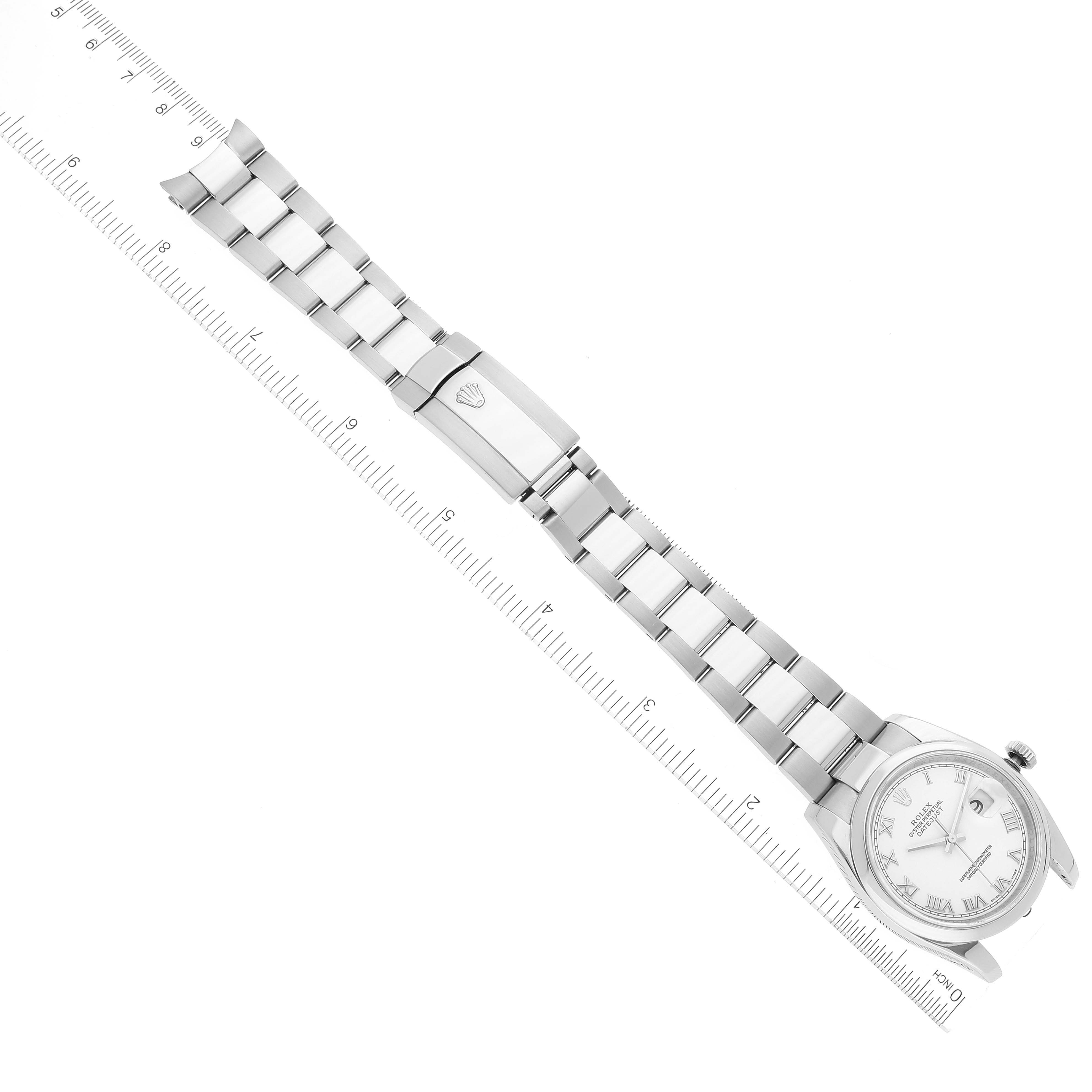 This image shows a top-down view of a Rolex Datejust 116200 Men's Stainless Steel White Dial 116200 Men's Stainless Steel White Dial watch, displaying the full metal band and clasp alongside a ruler for scale.
