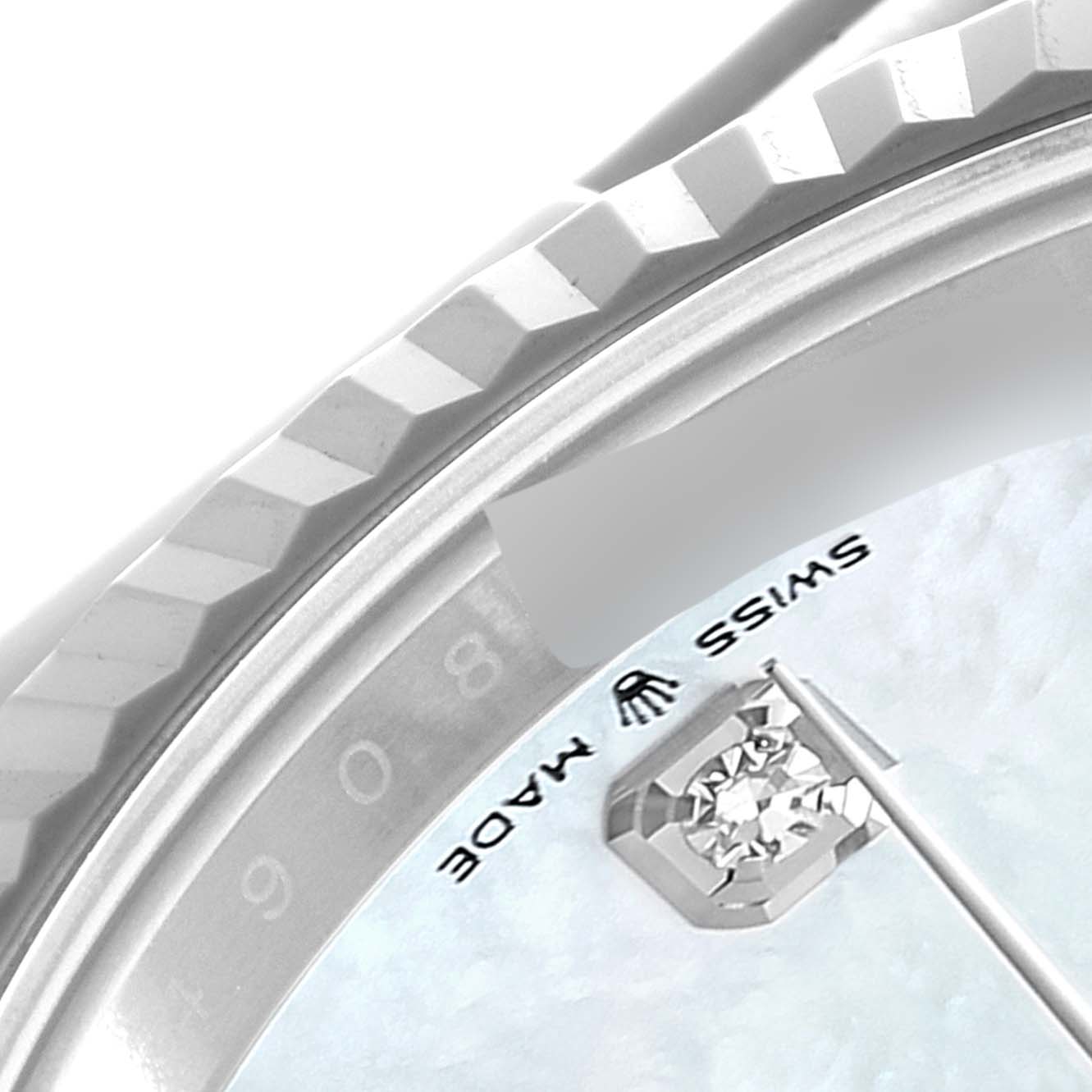 This close-up of a Rolex Datejust 41 126334 Men's Stainless Steel Mother of Pearl Dial 126334 Men's Stainless Steel Mother of Pearl Dial watch shows the fluted bezel and part of the dial with the "Swiss Made" marking.