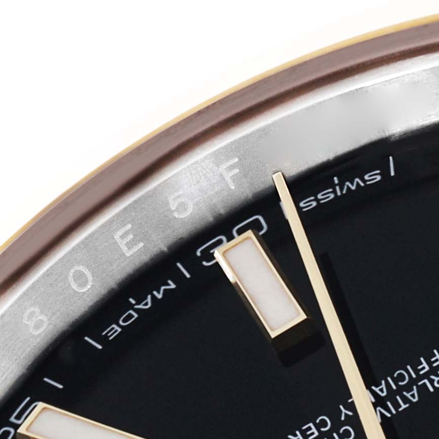 This image shows a close-up of the dial and part of the indices and bezel of the Rolex Datejust 41 126303 Men's Steel and Gold (two tone) Black Dial 126303 Men's Steel and Gold (two tone) Black Dial model.