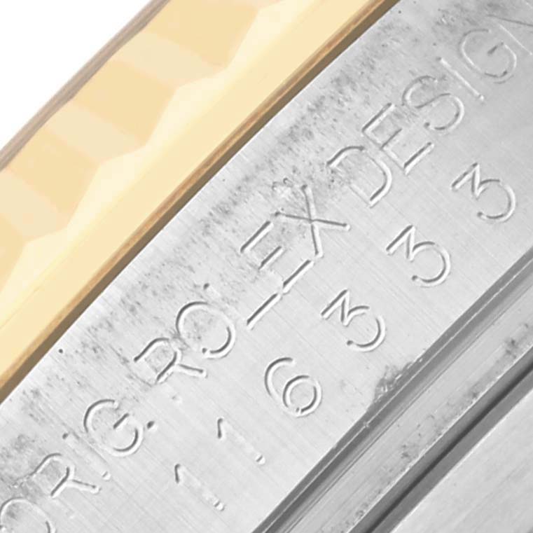The image shows an up-close view of the Rolex Datejust 41 116333 Men's Steel and Gold (two tone) Black Dial 116333 Men's Steel and Gold (two tone) Black Dial, highlighting the engravings on the case edge.