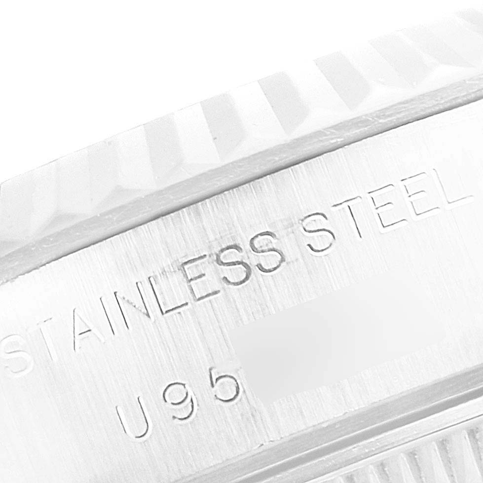 The image shows a close-up of the stainless steel case and fluted bezel of a Rolex Datejust 69174 Women's Stainless Steel Mother of Pearl Dial 69174 Women's Stainless Steel Mother of Pearl Dial watch.