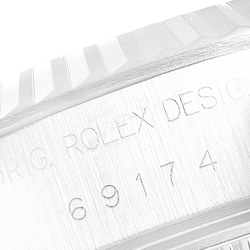 The image shows a macro shot of the case side and bezel of a Rolex Datejust 69174 Women's Stainless Steel Mother of Pearl Dial 69174 Women's Stainless Steel Mother of Pearl Dial model.