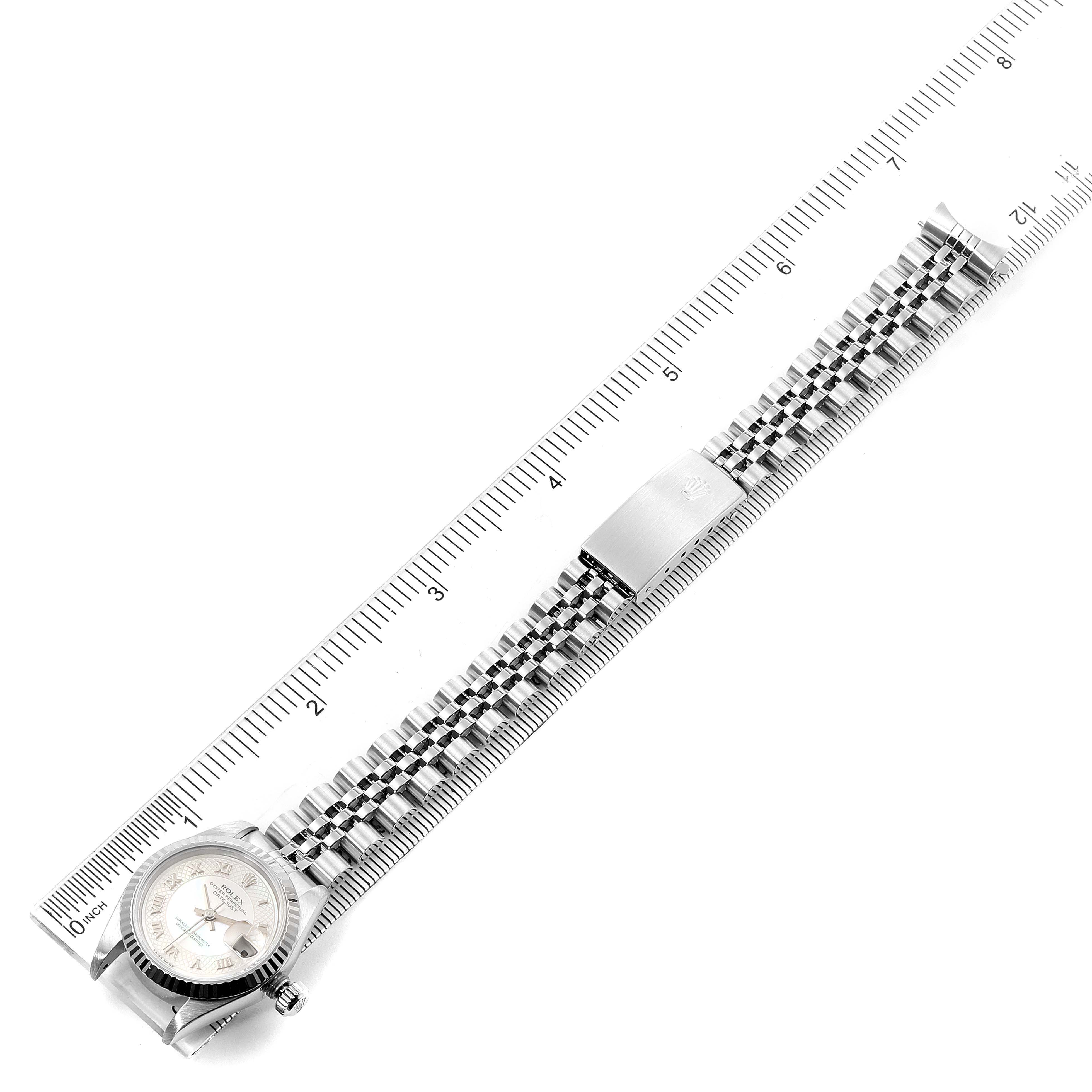 The image shows a Rolex Datejust 69174 Women's Stainless Steel Mother of Pearl Dial 69174 Women's Stainless Steel Mother of Pearl Dial watch laid flat, featuring its face, band, and clasp with a measuring ruler beside it.