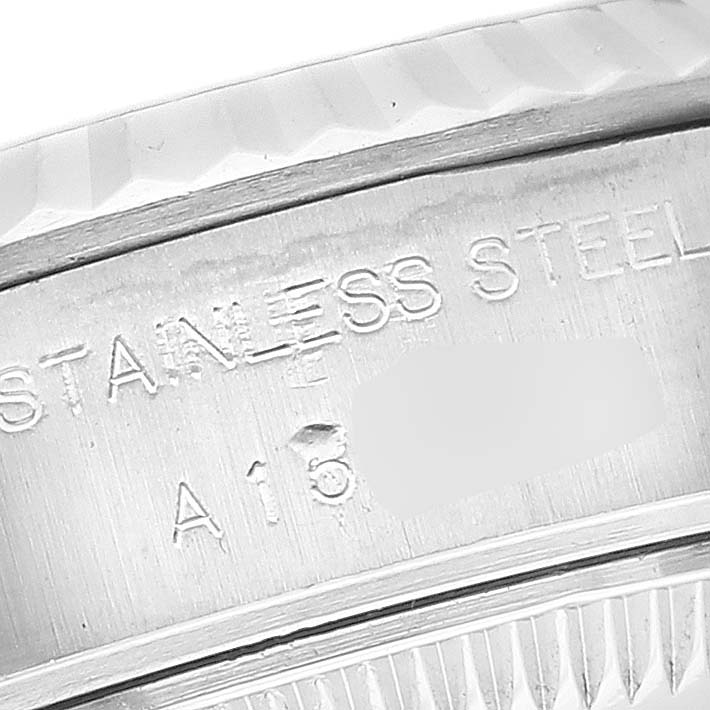This close-up image shows the engraved text on the stainless steel casing of a Rolex Datejust 69174 Women's Stainless Steel White Dial 69174 Women's Stainless Steel White Dial model watch.