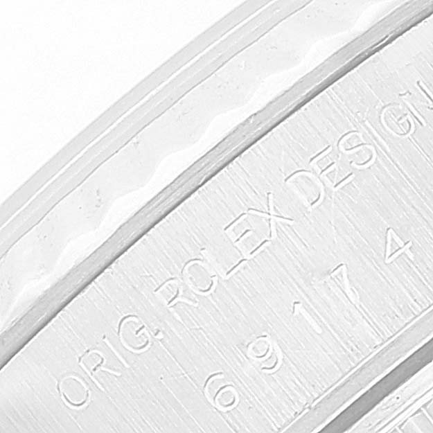 This image shows a close-up of the engravings on the side of the bezel of a Rolex Datejust 69174 Women's Stainless Steel Silver Dial 69174 Women's Stainless Steel Silver Dial watch.