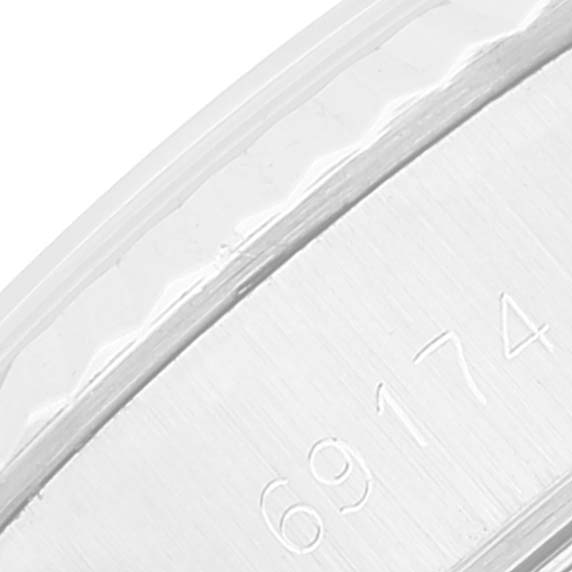 This close-up image shows part of the Rolex Datejust 69174 Women's Stainless Steel Silver Dial 69174 Women's Stainless Steel Silver Dial's case with the model number engraved.