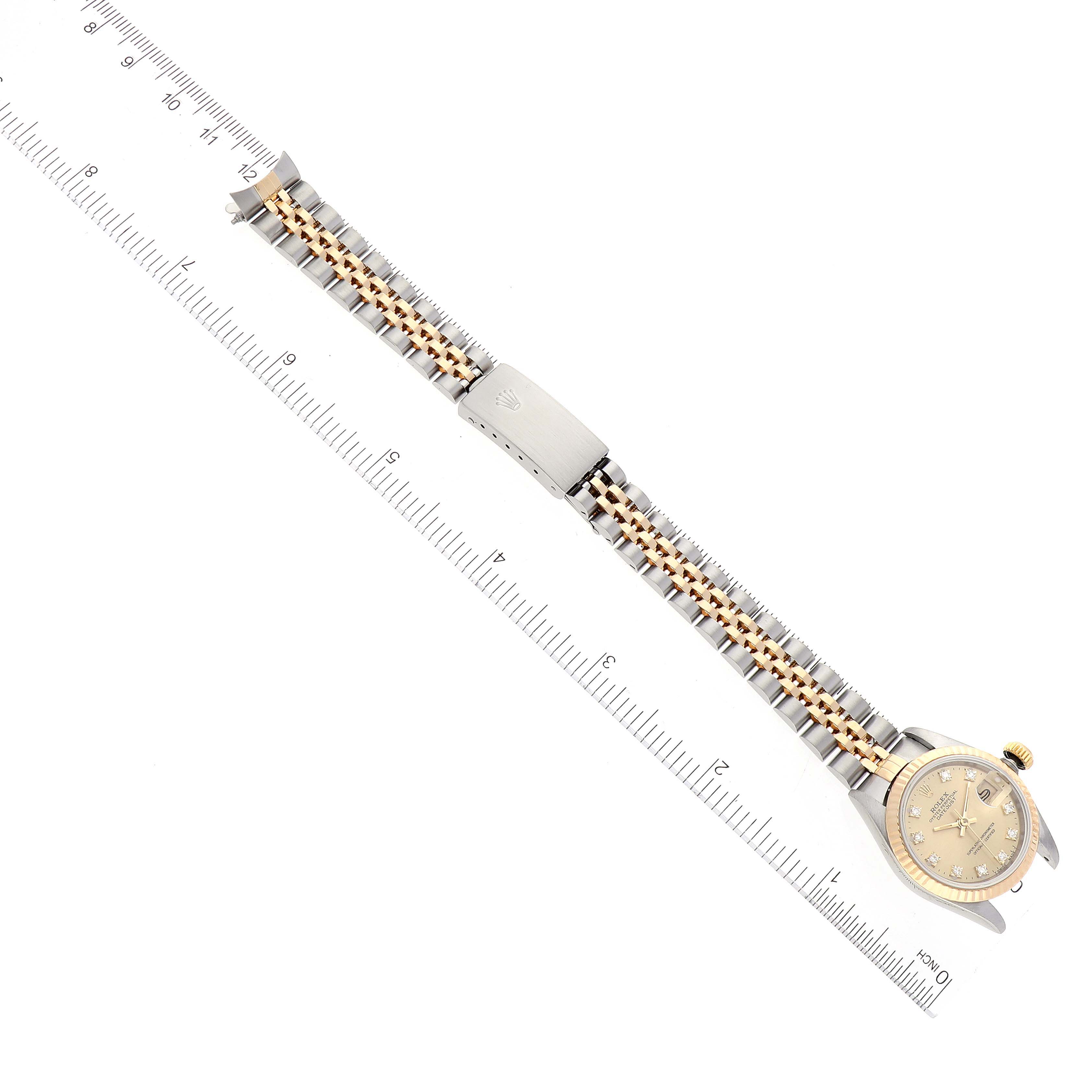 The image shows the full length of a Rolex Datejust 69173 Women's Steel and Gold (two tone) Champagne Dial 69173 Women's Steel and Gold (two tone) Champagne Dial watch, including its band and face, positioned alongside a ruler.