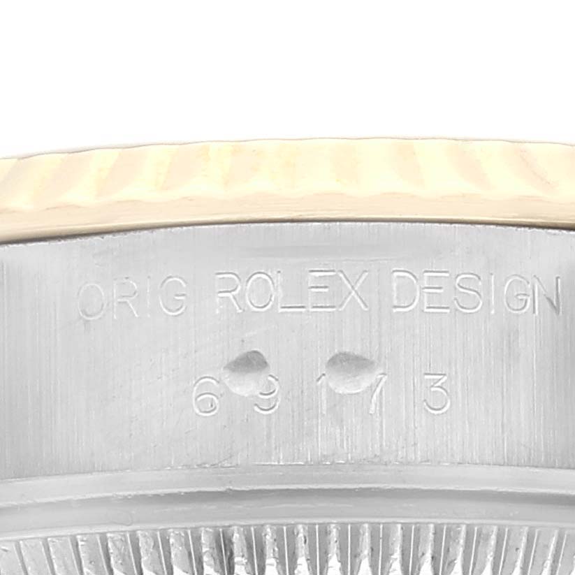 The image shows a close-up of the side case with engraved markings of a Rolex Datejust 69173 Women's Steel and Gold (two tone) Champagne Dial 69173 Women's Steel and Gold (two tone) Champagne Dial watch.