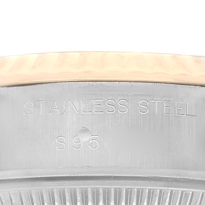 This close-up image shows the caseback edge and part of the fluted bezel of the Rolex Datejust 69173 Women's Steel and Gold (two tone) Champagne Dial 69173 Women's Steel and Gold (two tone) Champagne Dial watch, highlighting the "STAINLESS STEEL" engraving.
