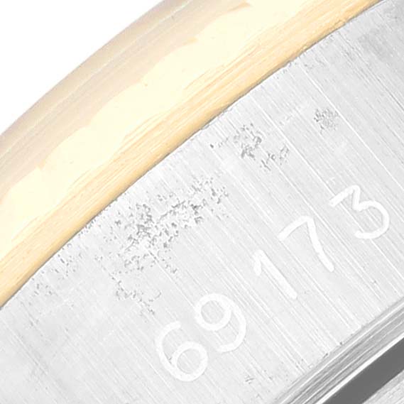 The image shows a close-up of the side of a Rolex Date 69173 Women's Steel and Gold (two tone) Champagne Dial 69173 Women's Steel and Gold (two tone) Champagne Dial model watch, highlighting the engraved serial number.